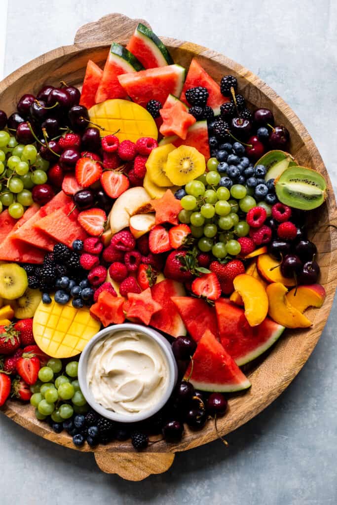 cut up arranged fruit with a creamy dip.