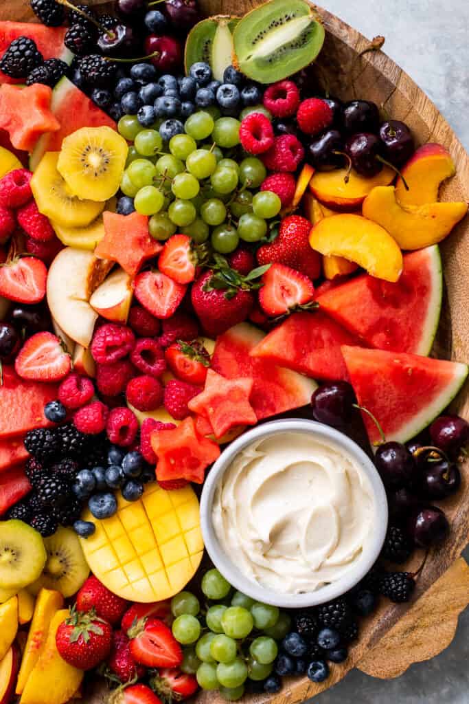 arranged fruit platter on a wooden tray.