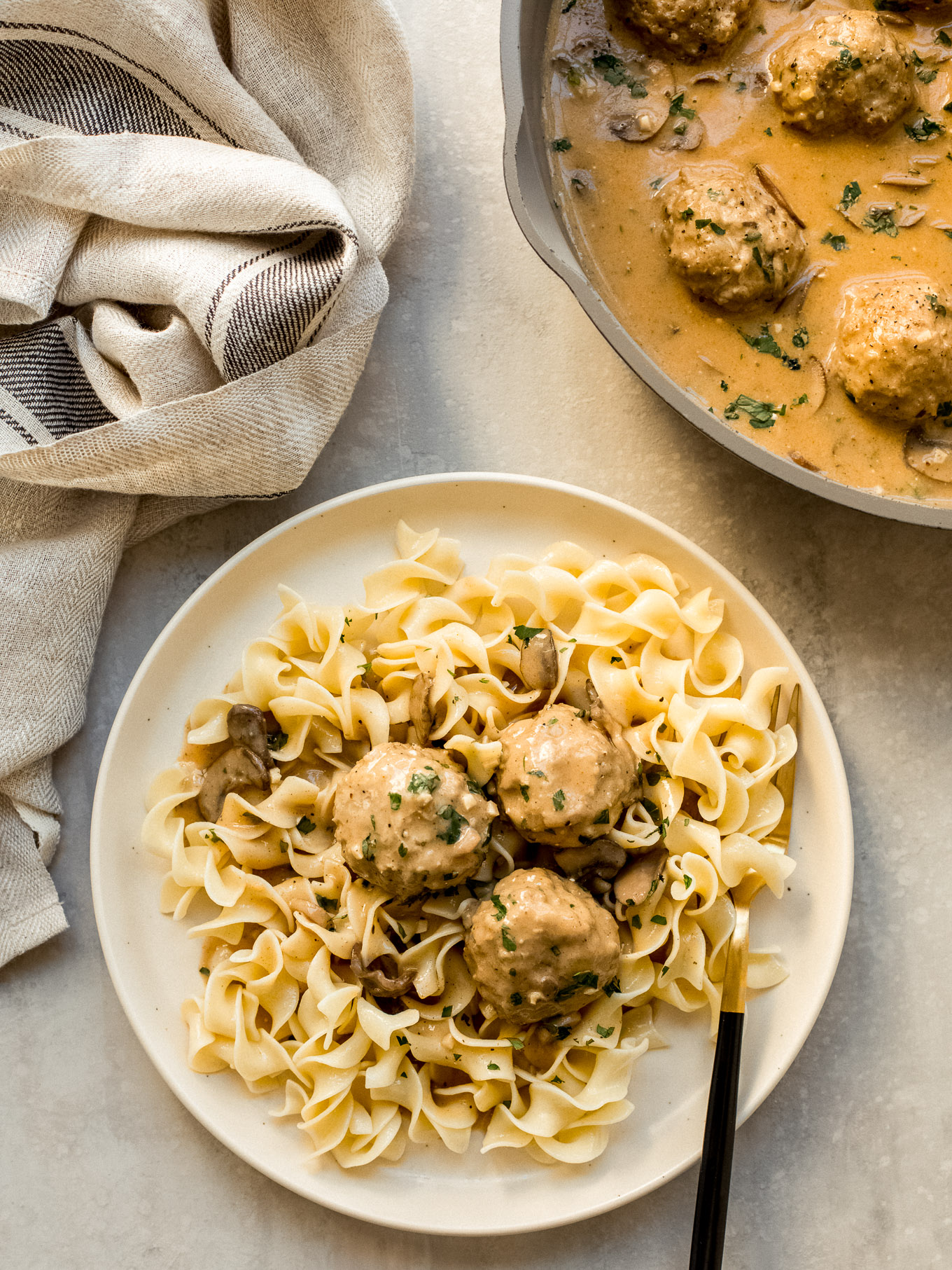 chicken meatball stroganoff with egg noodles on a plate.