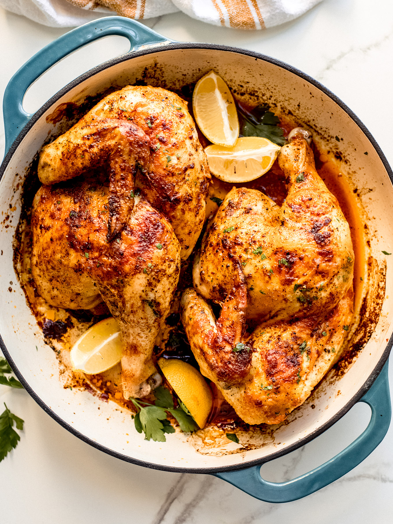 roasted half chicken in a saute pan.
