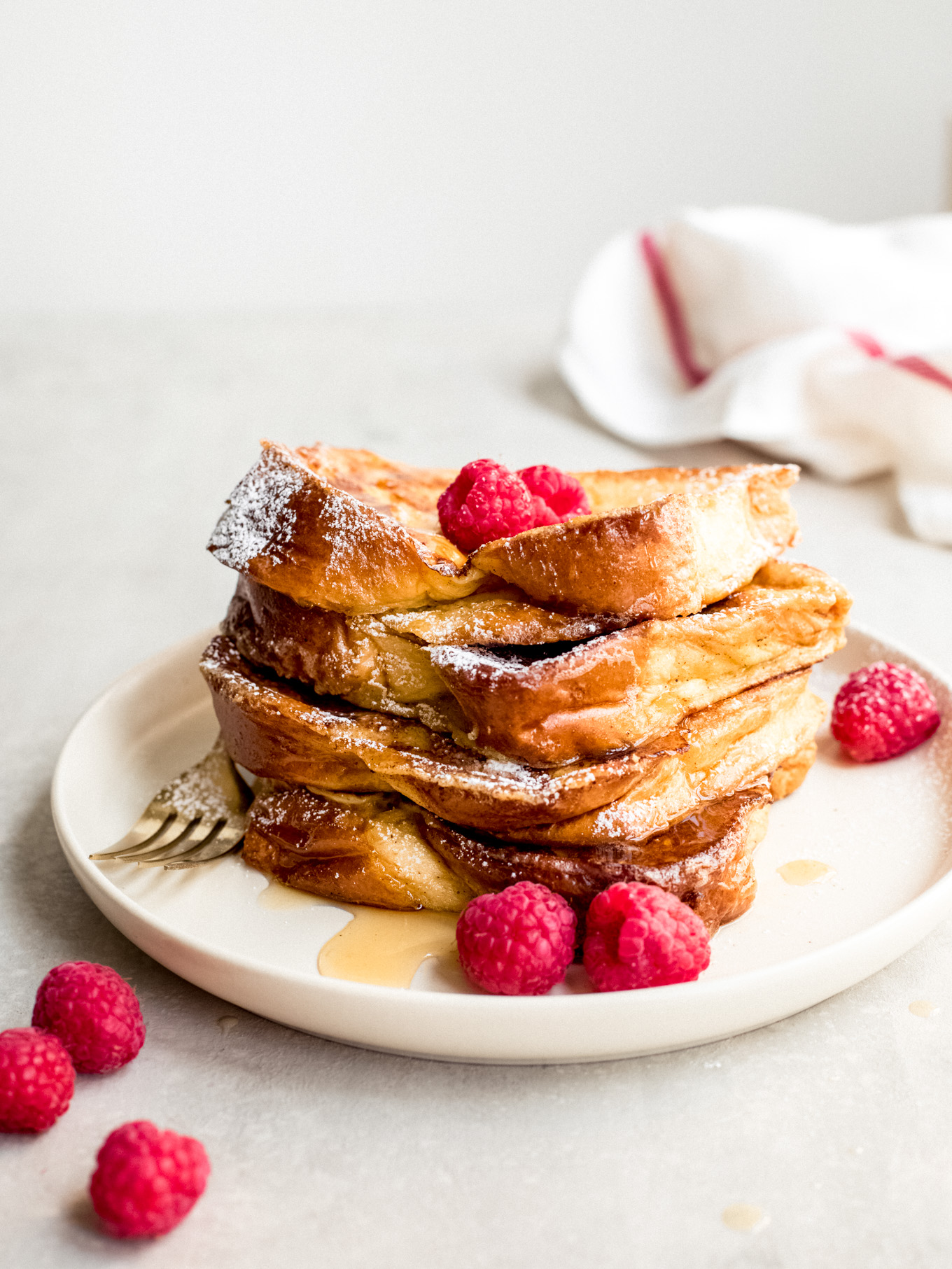 brioche french toast recipe stacked on plate.