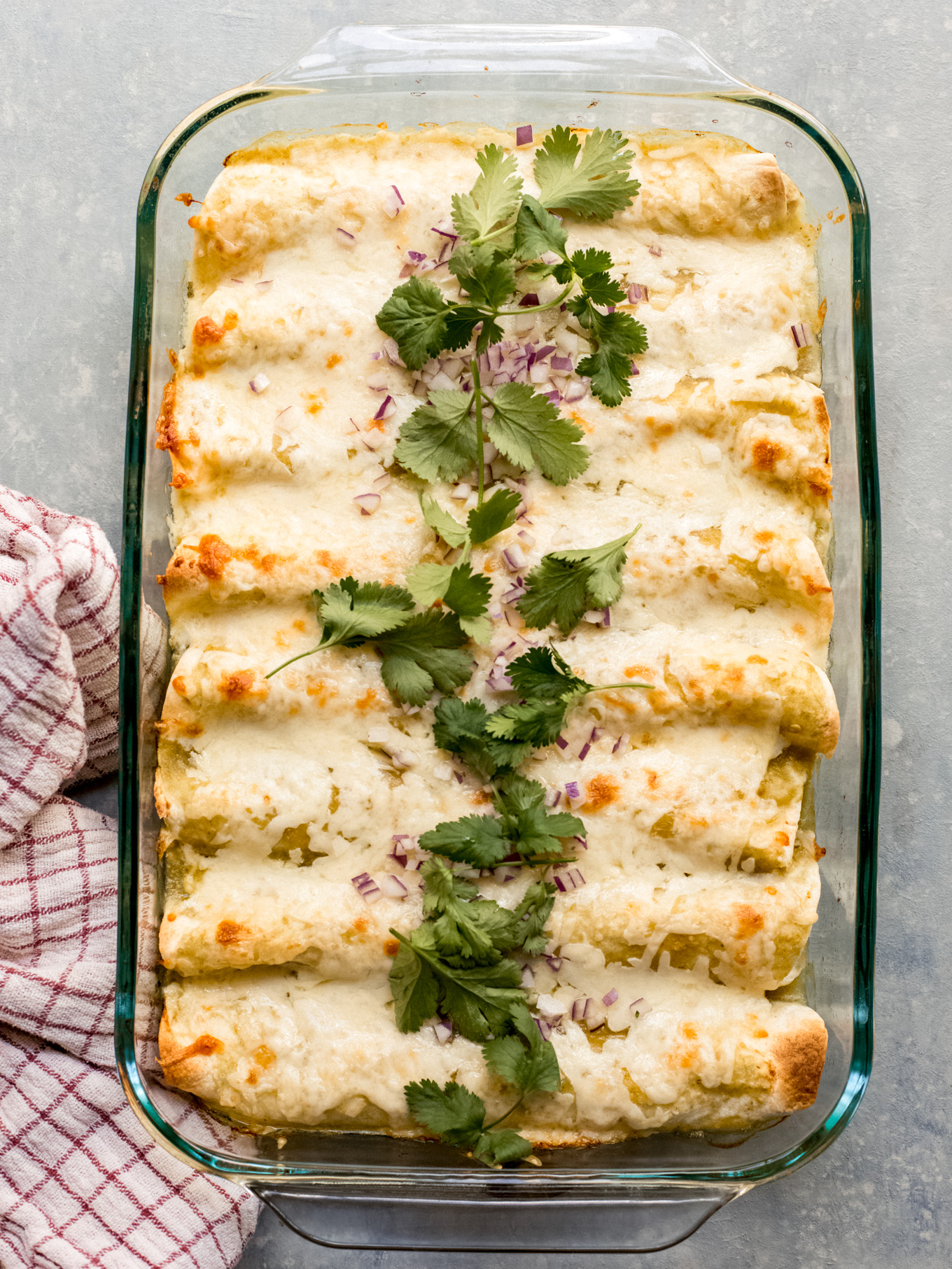 enchiladas verdes in glass baking dish.