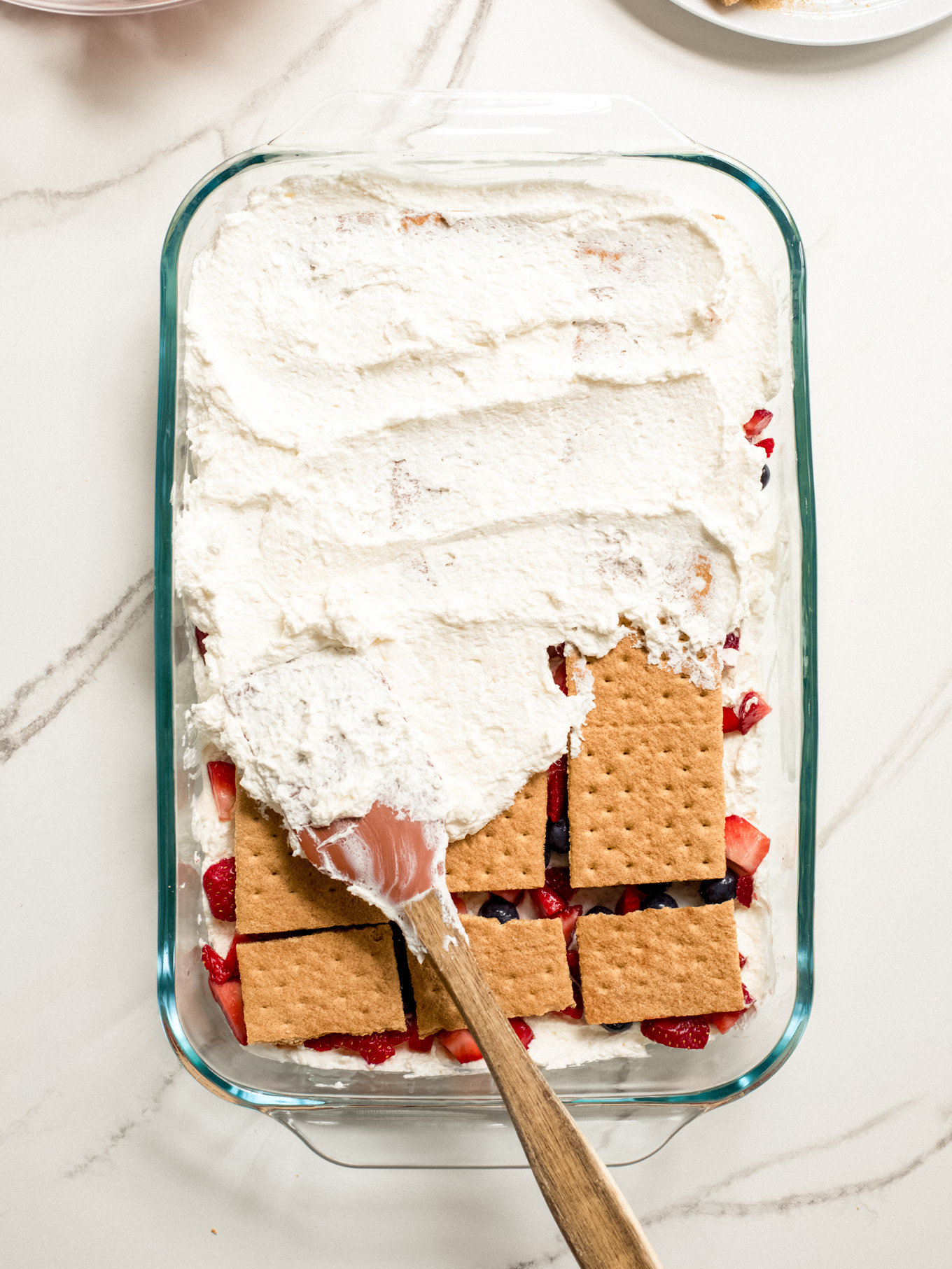 whipped cream spread over graham crackers with a rubber spatula.
