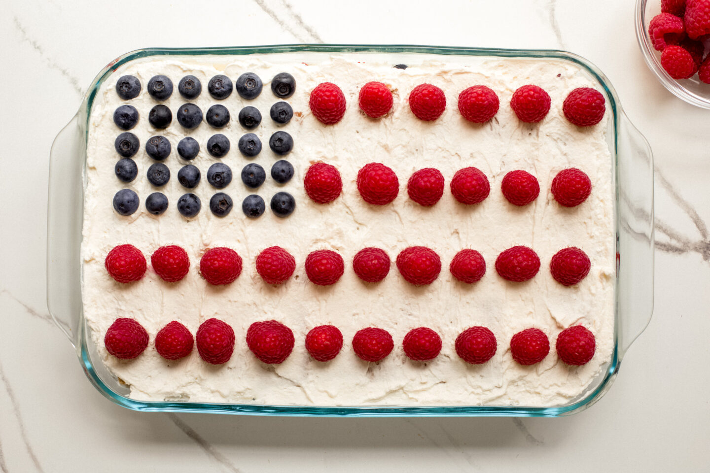cake decorated with berries to look like American flag.