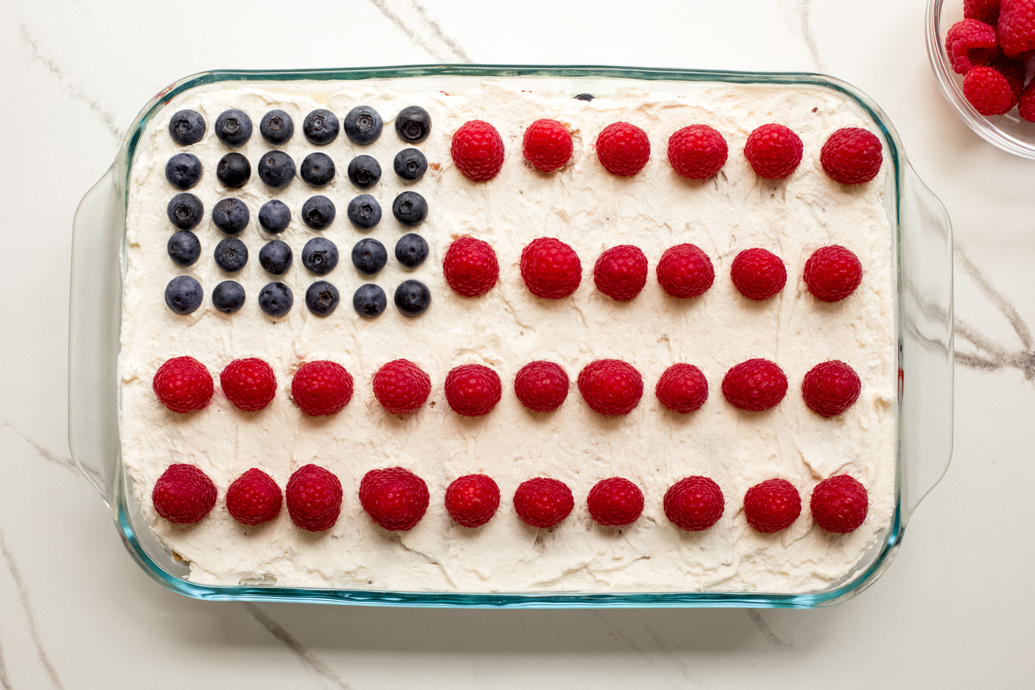 cake decorated with berries to look like American flag.