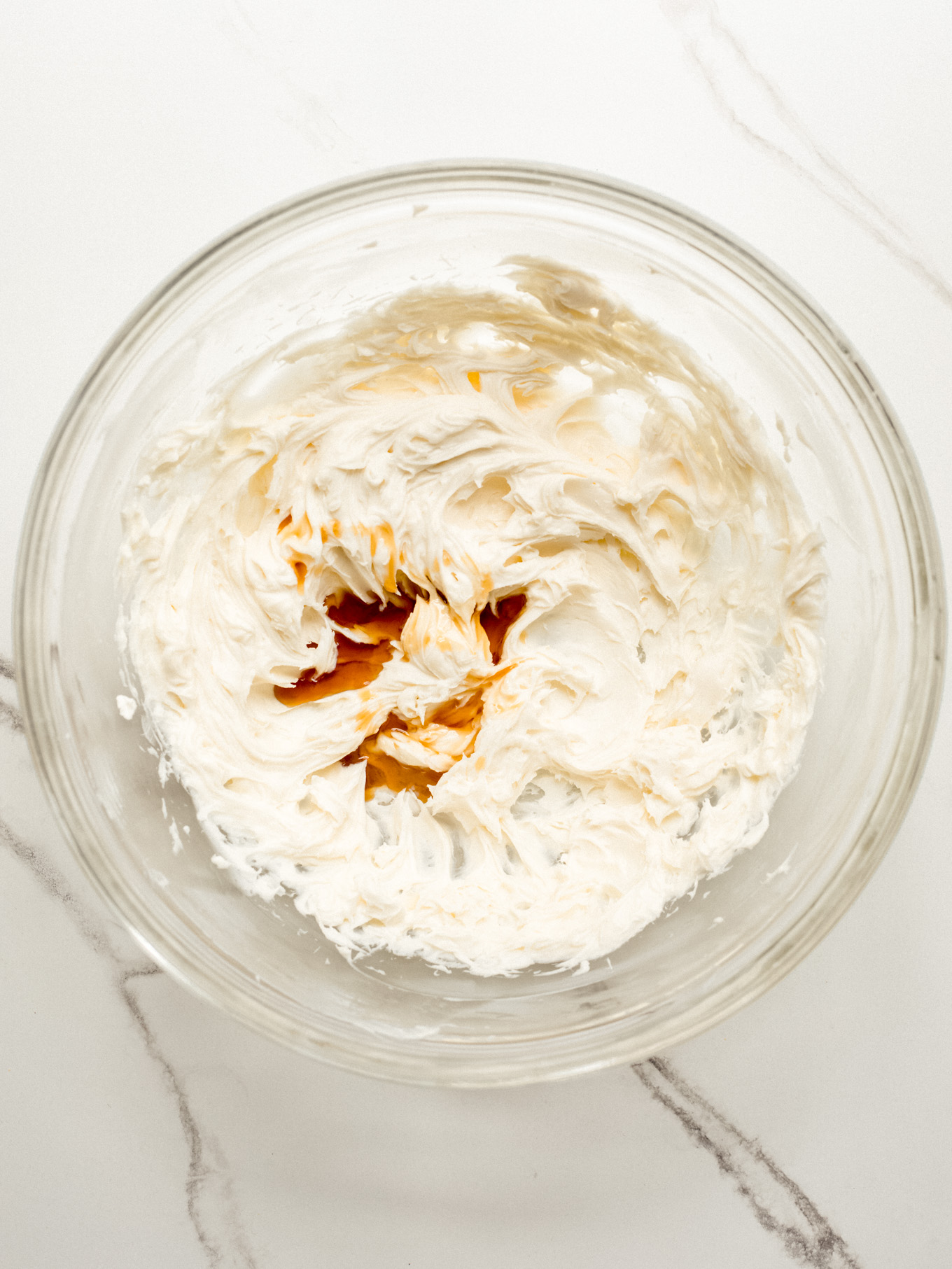 whipped cream cheese with vanilla extract in a bowl.
