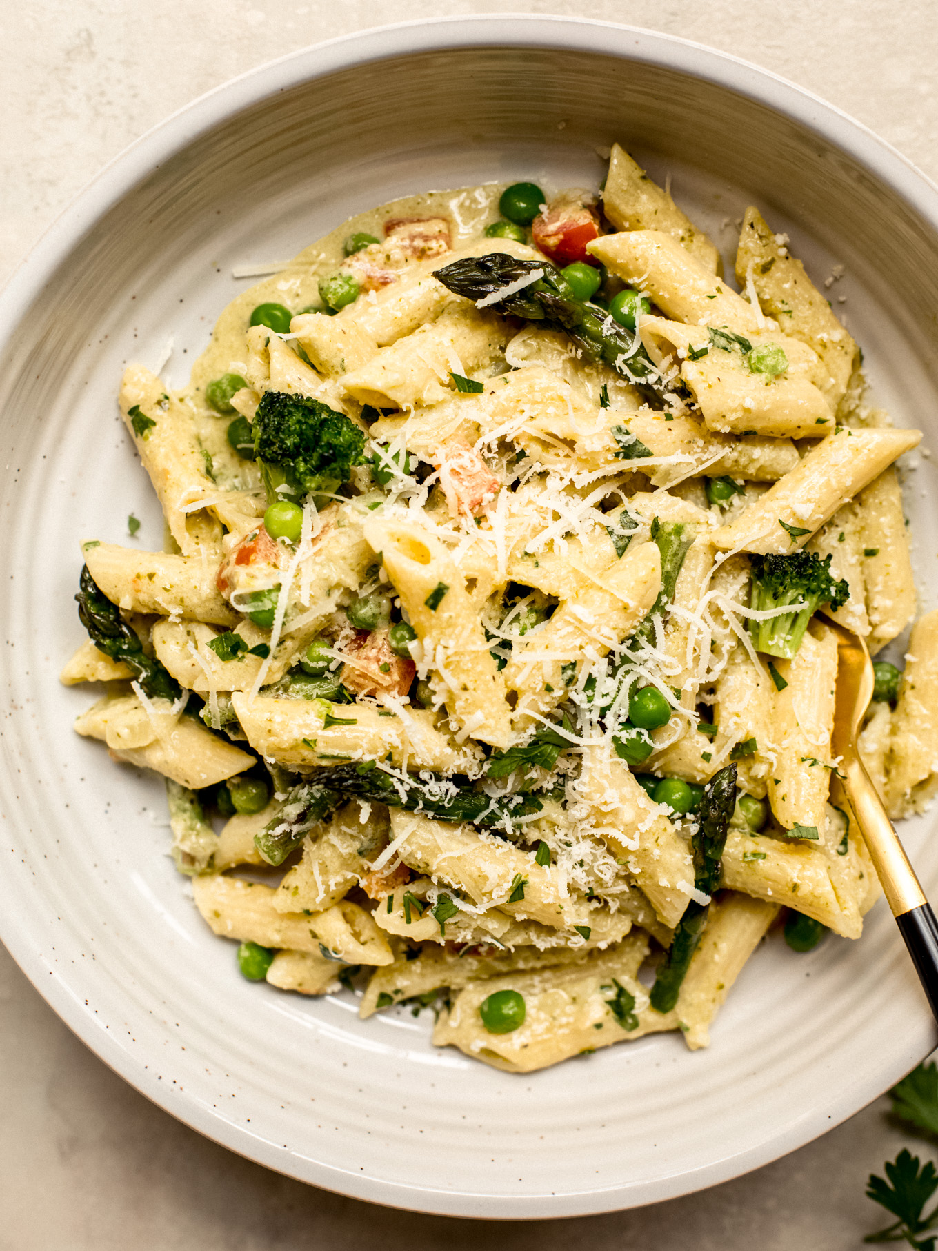 penne pasta with creamy sauce and vegetables in a bowl.