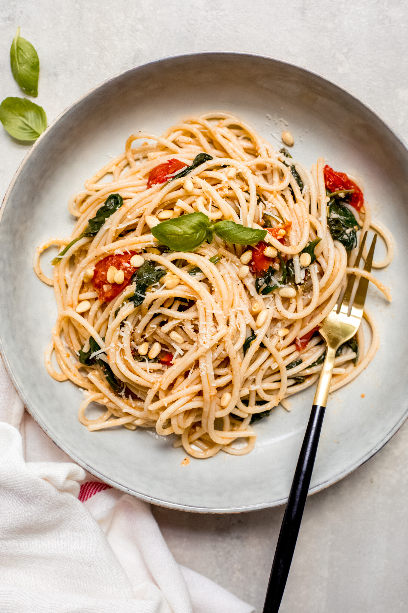 spaghetti with fresh tomato sauce in a bowl with a side of fork.