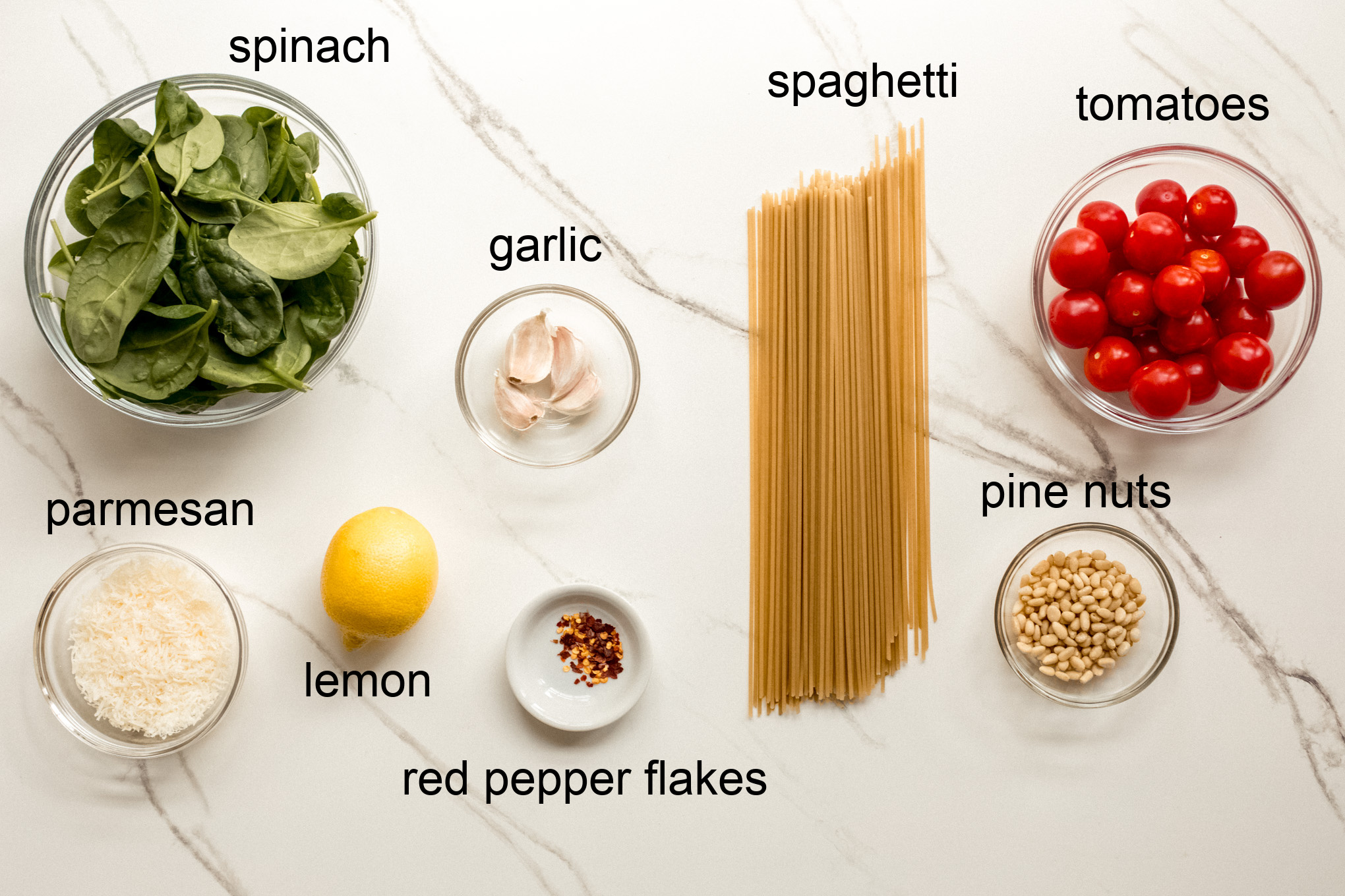 ingredients for pasta with spinach and tomatoes.
