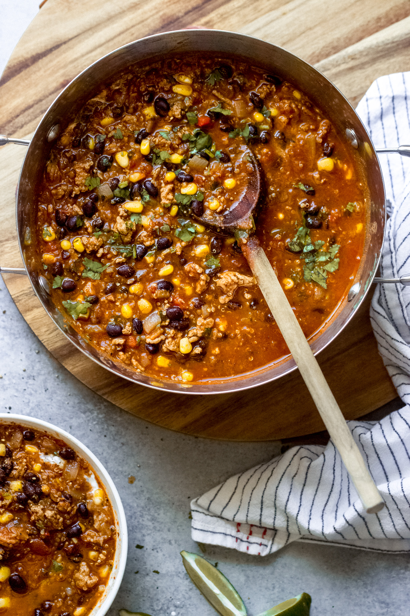 turkey chili in a pot with a wooden spoon.