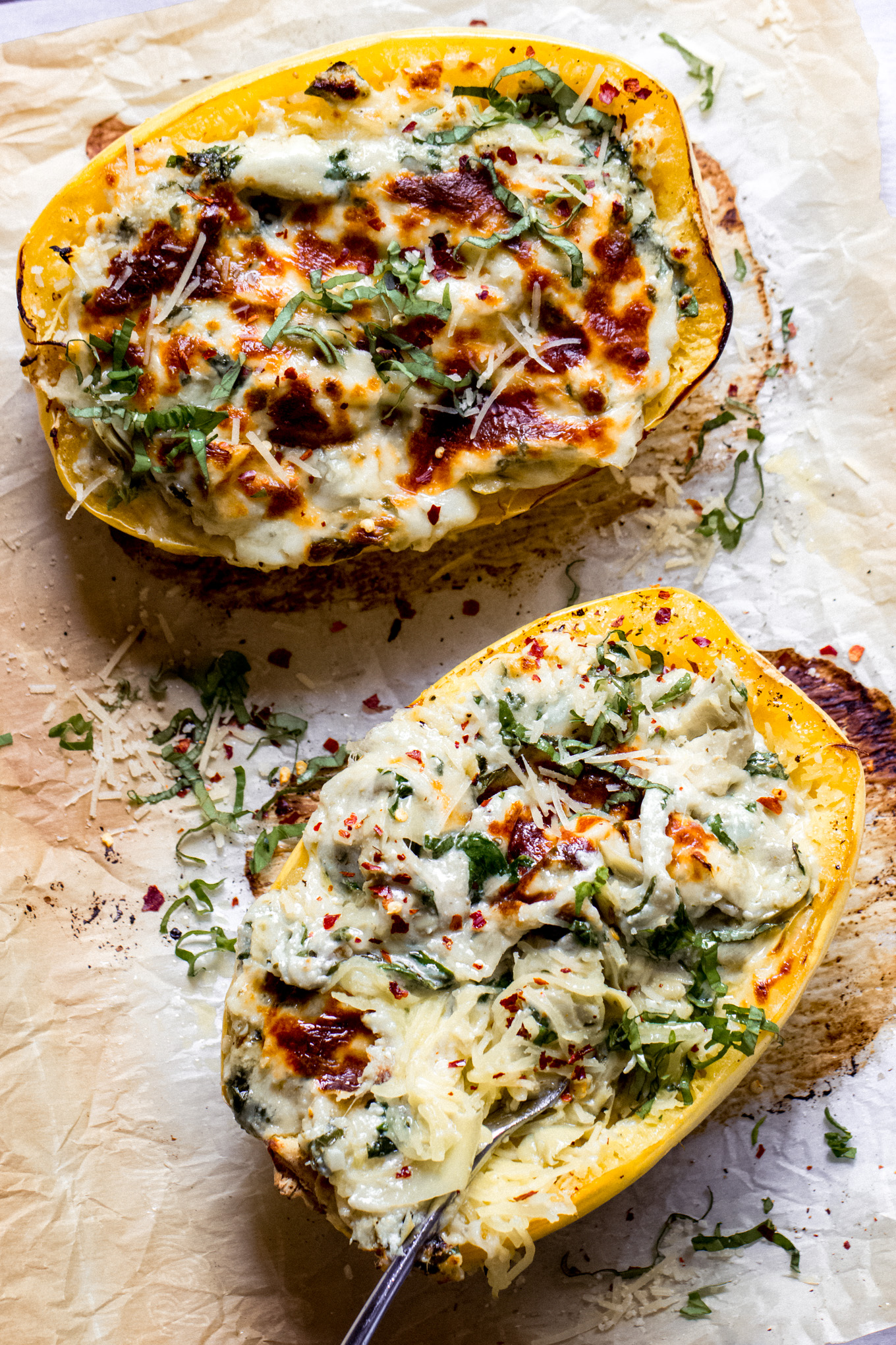 twice baked spaghetti squash with artichokes, spinach, and cheese.