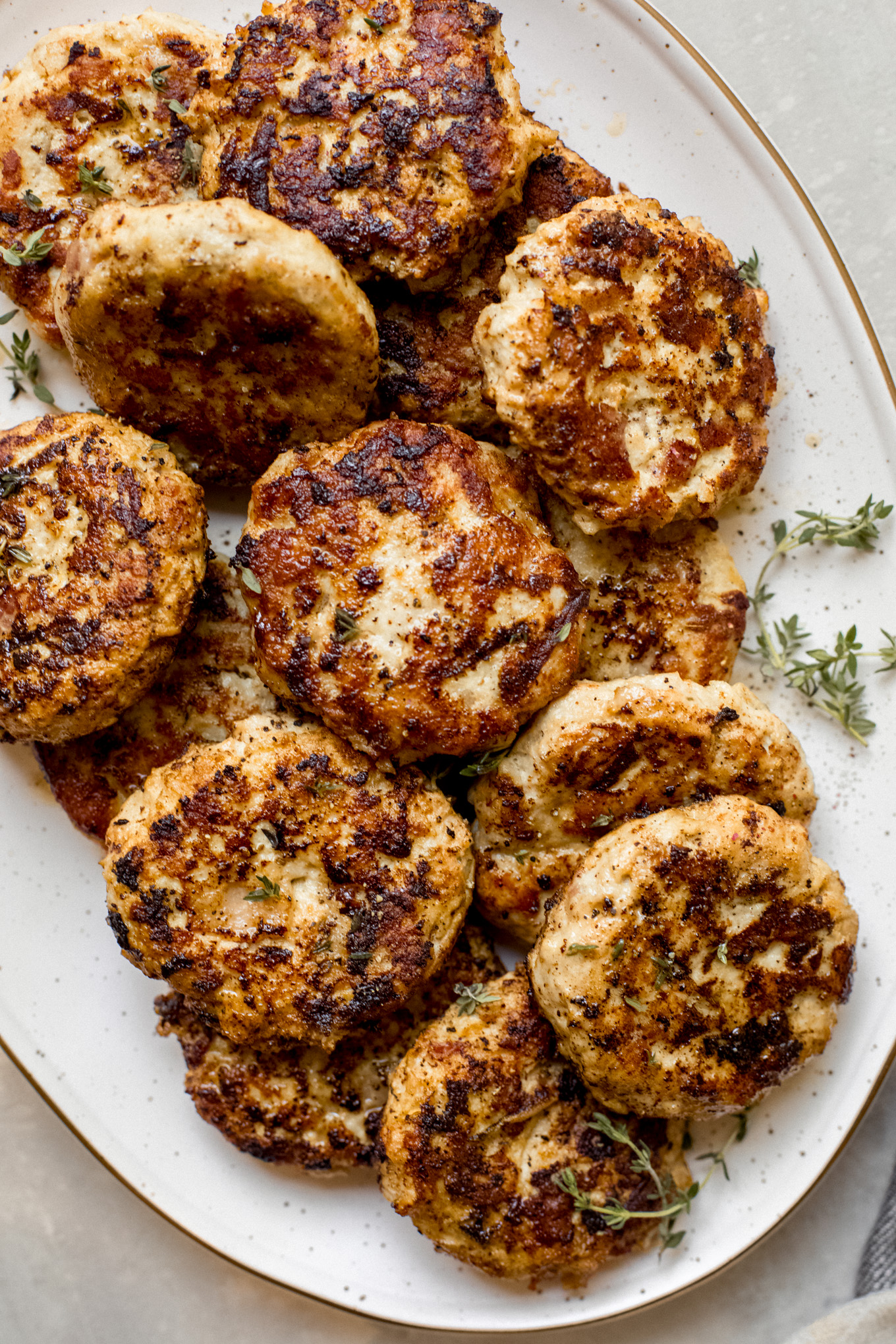 chicken apple sausage on a white oval platter.