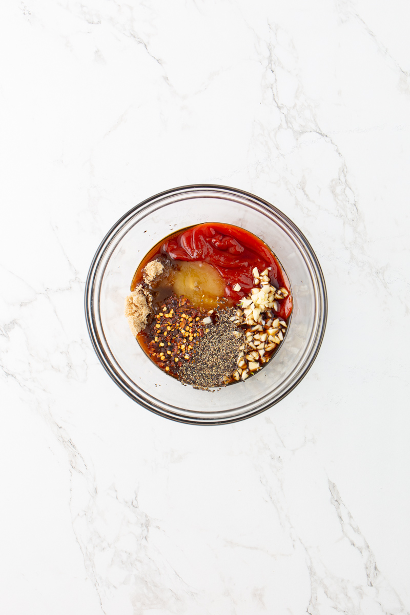 sweet and spicy sauce ingredients in a glass bowl.