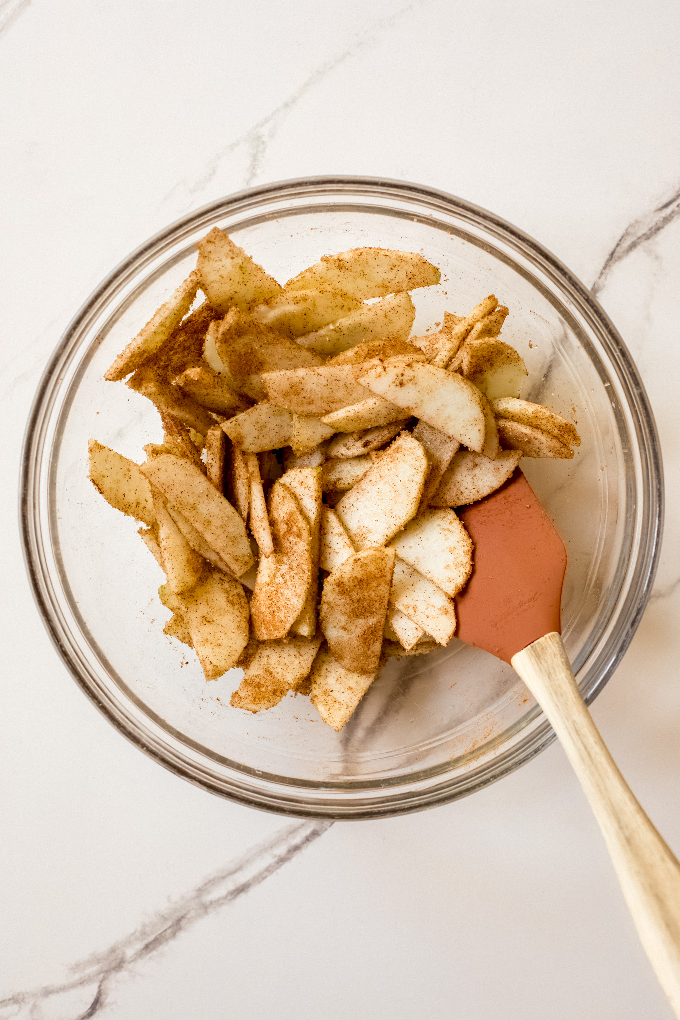 sliced apples with cinnamon in a bowl.