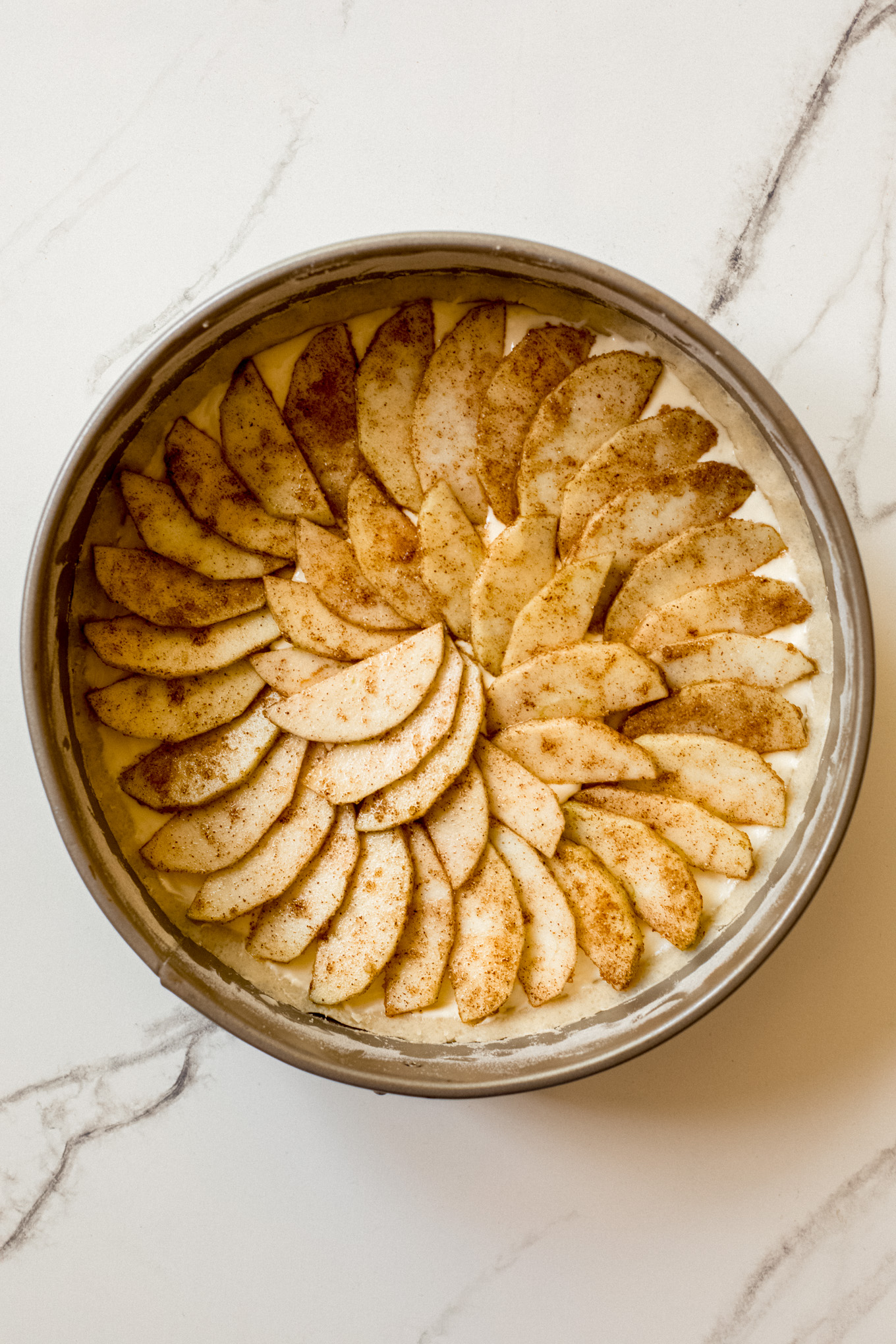 apple slices spread over the tart.