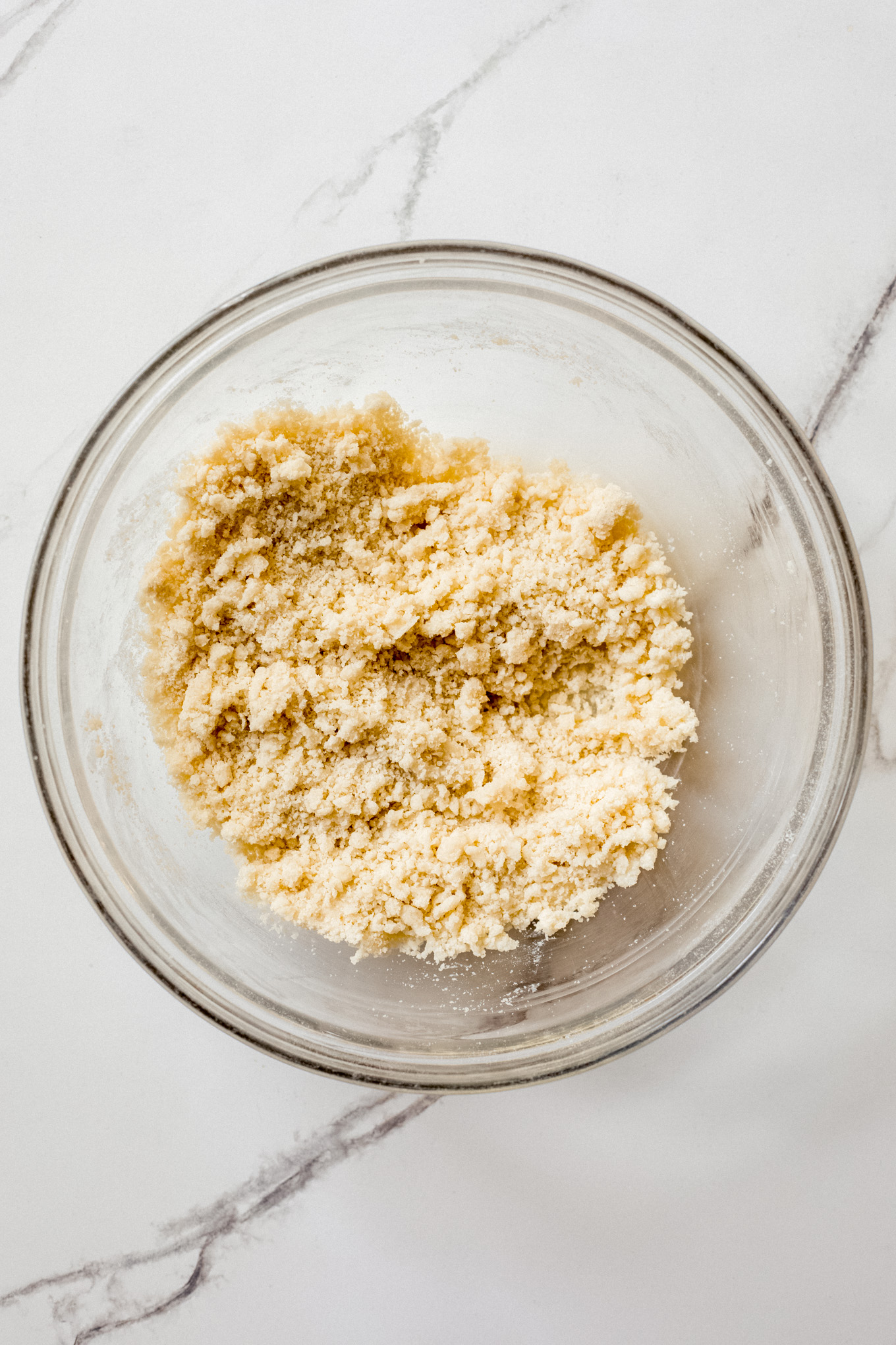 crumbled dough in a glass bowl.