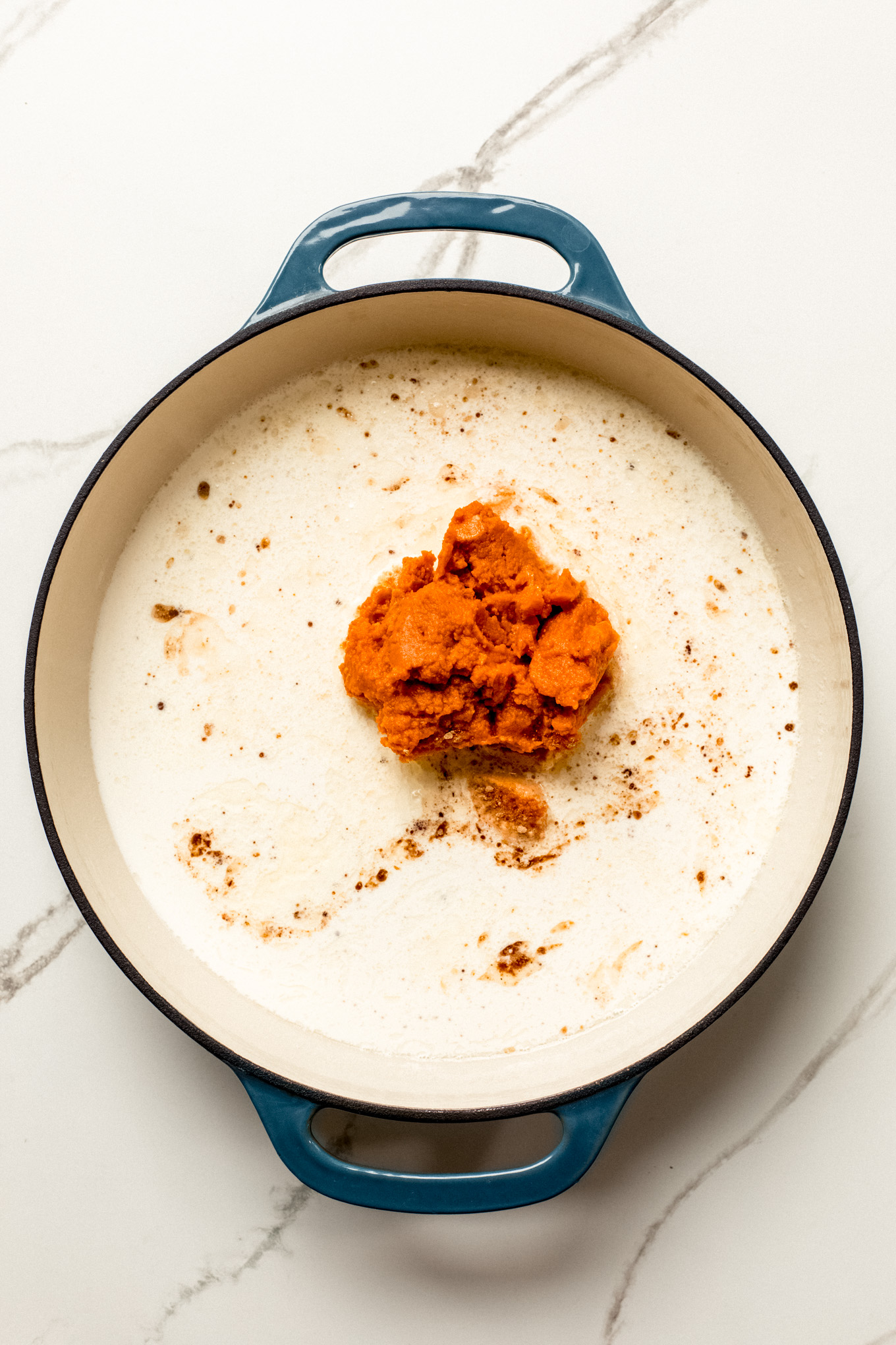 half and half and pumpkin puree in a skillet.