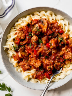 sausage cacciatore over cooked egg noodles.