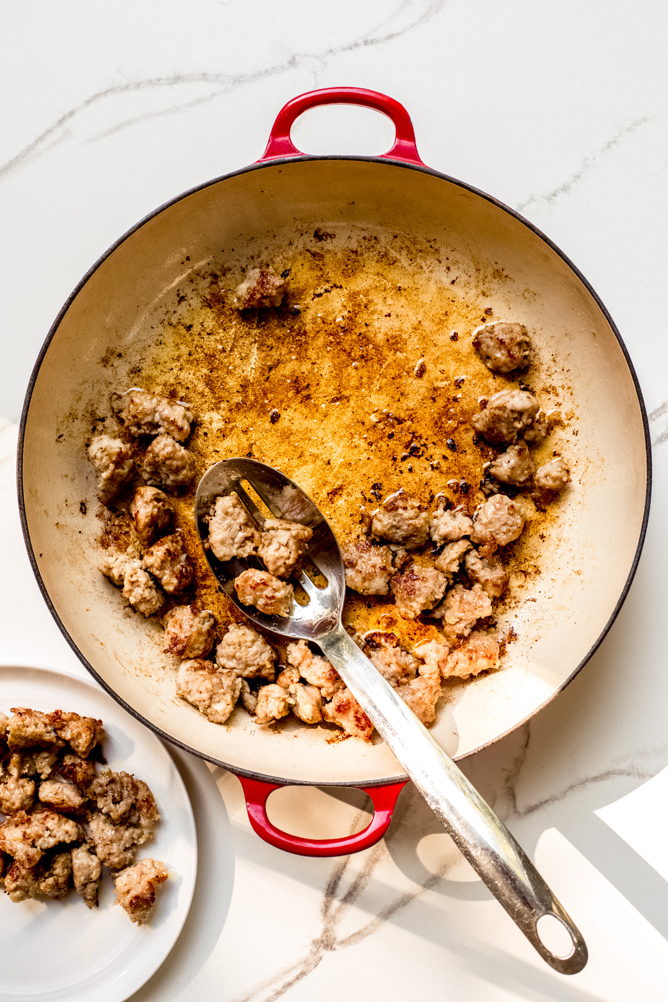 cooked Italian sausage in a saute pan.