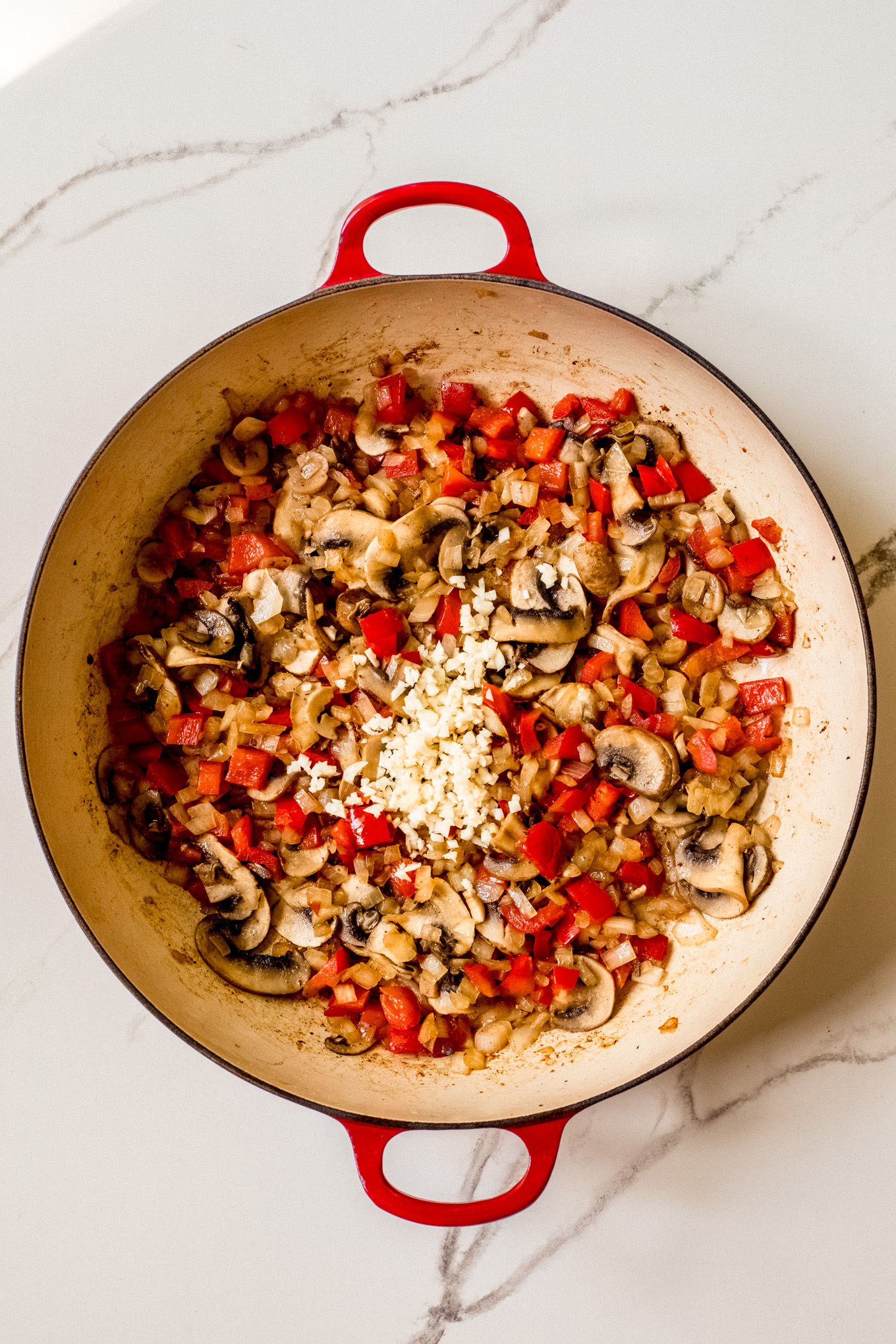 cooked vegetables with garlic in a pan.