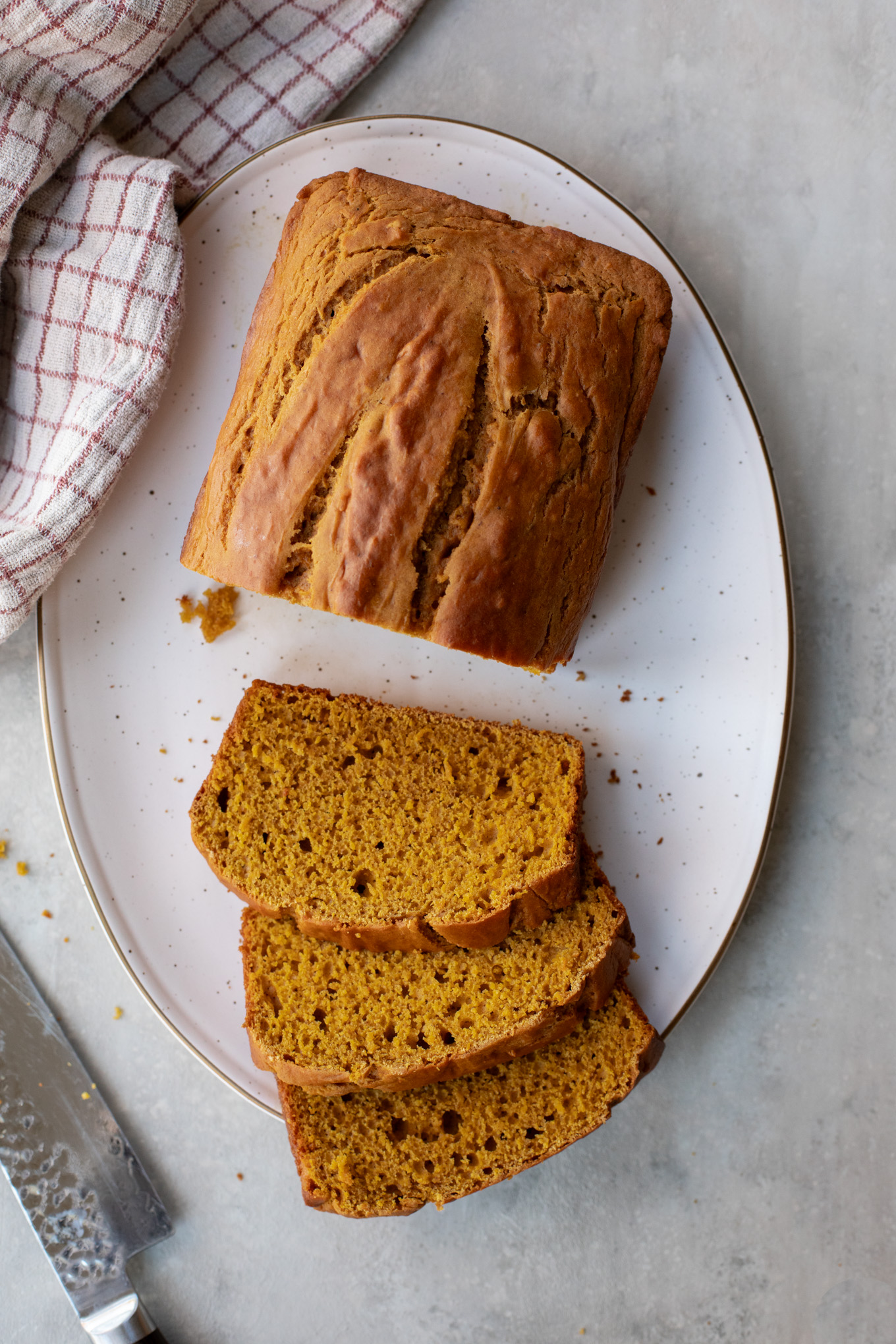 sliced loaf of pumpkin bread on a platter.