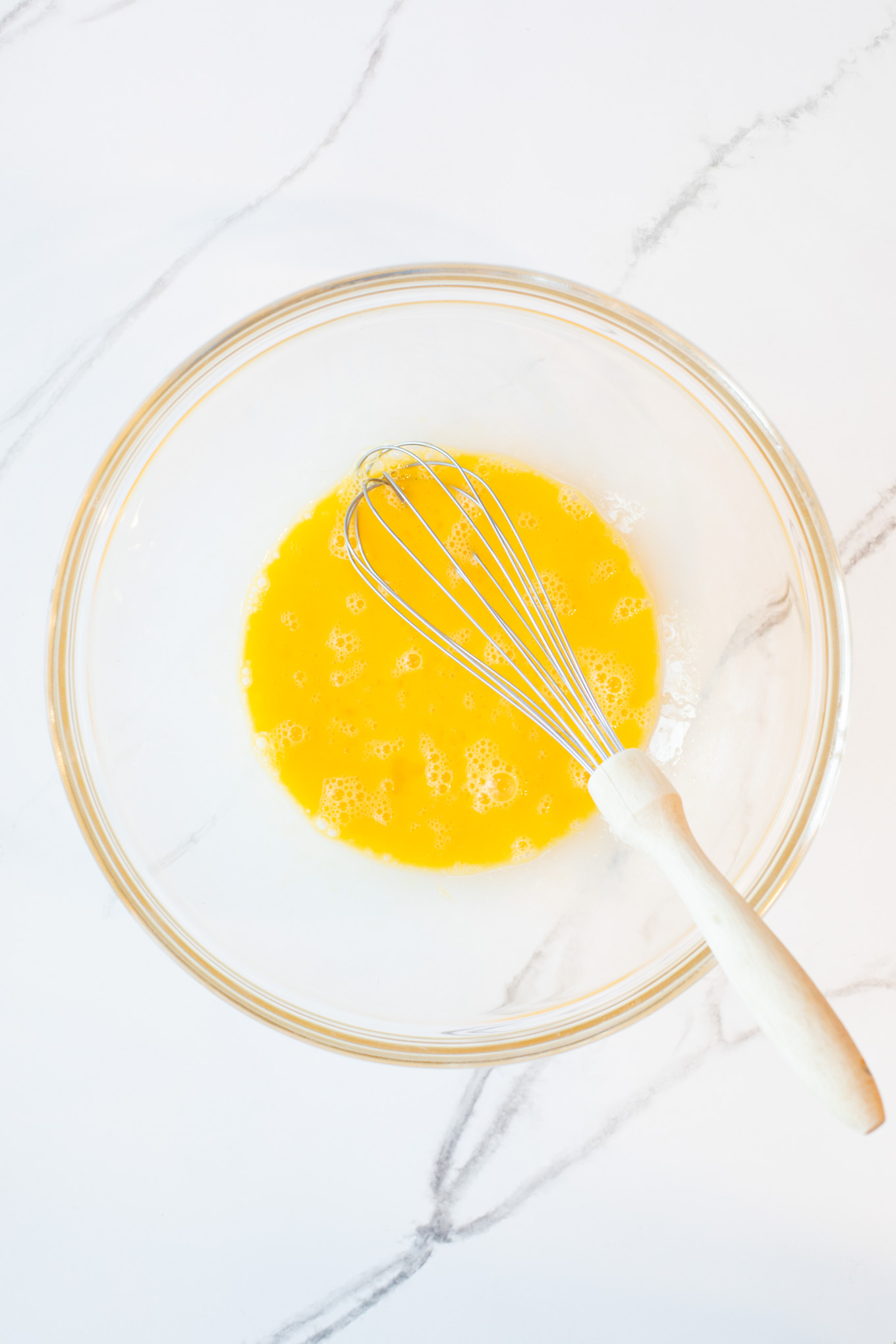 beaten eggs in a glass bowl.