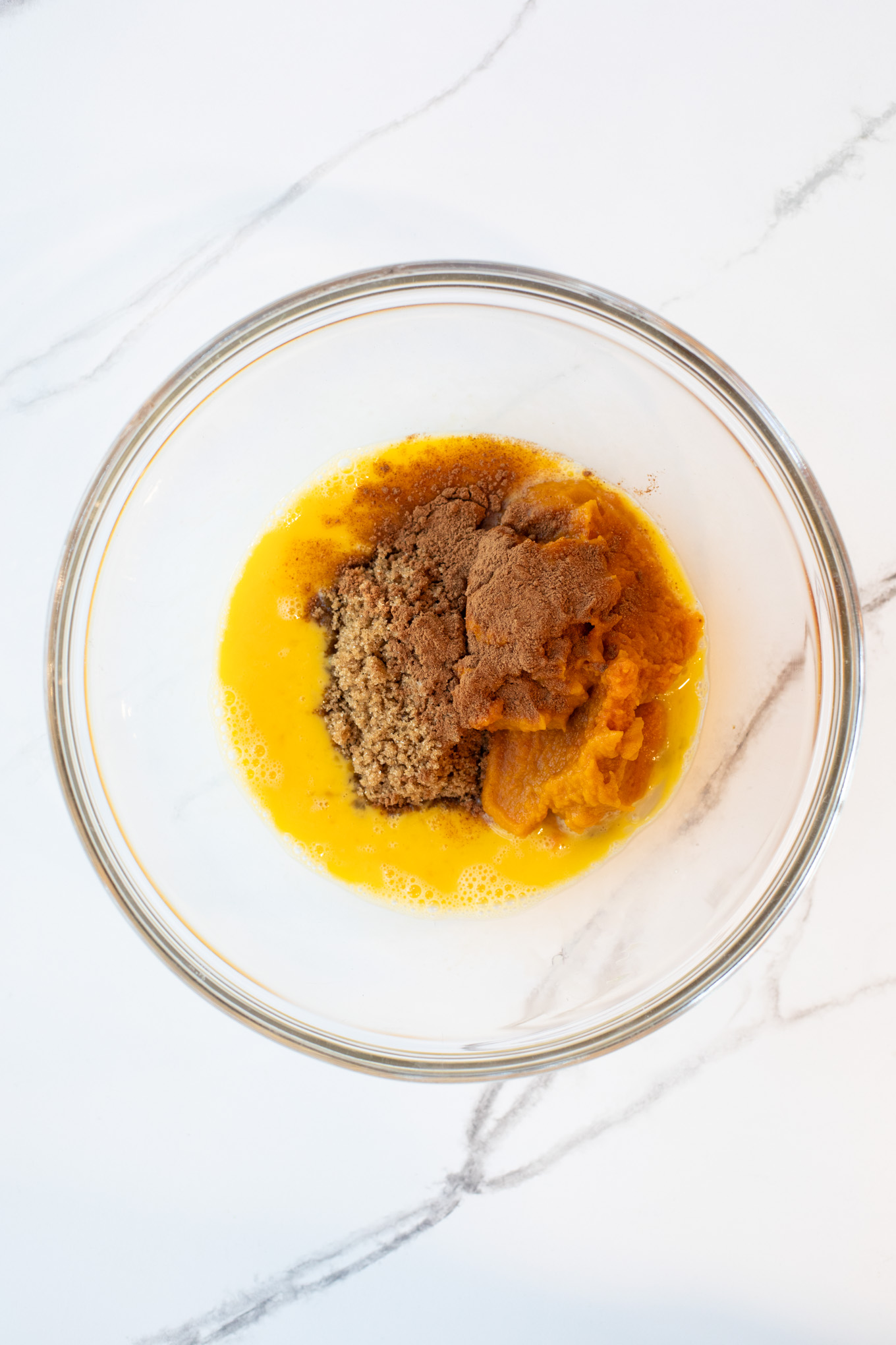 wet ingredients for pumpkin bread in a glass bowl.