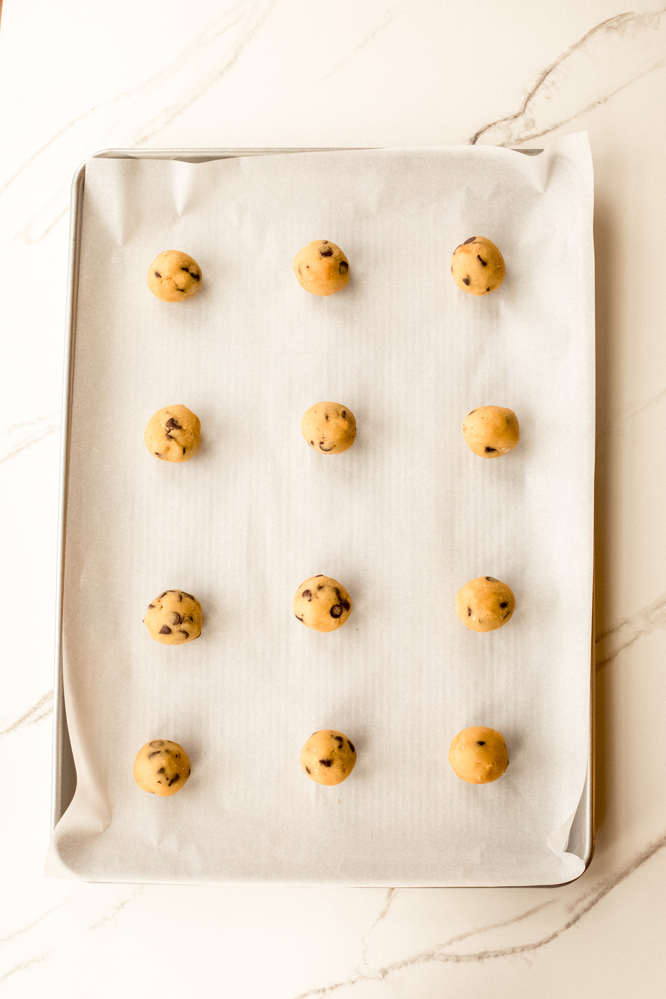 rolled up cookie dough on a baking sheet.