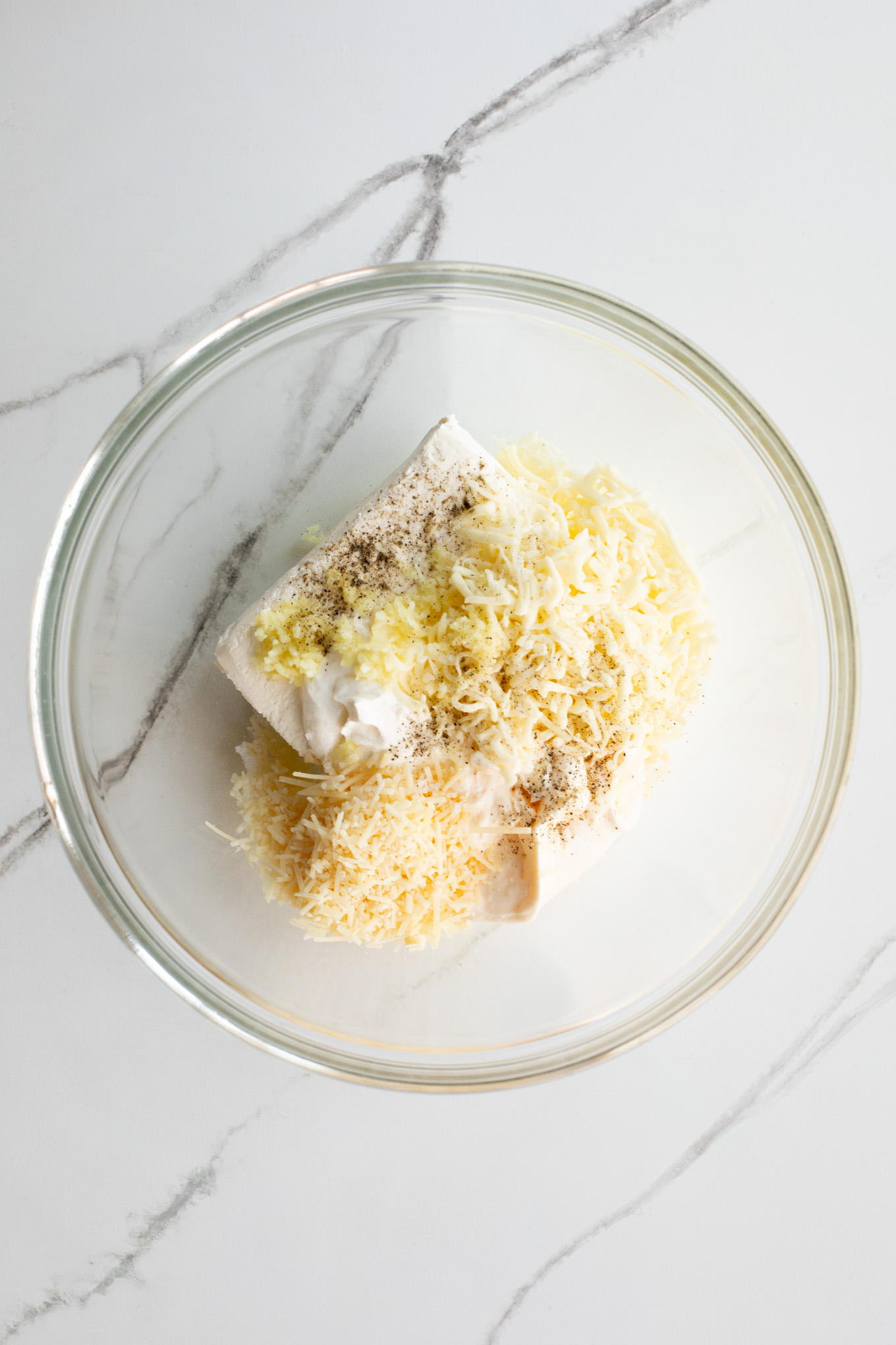 cream  cheese and cheese in a glass mixing bowl.