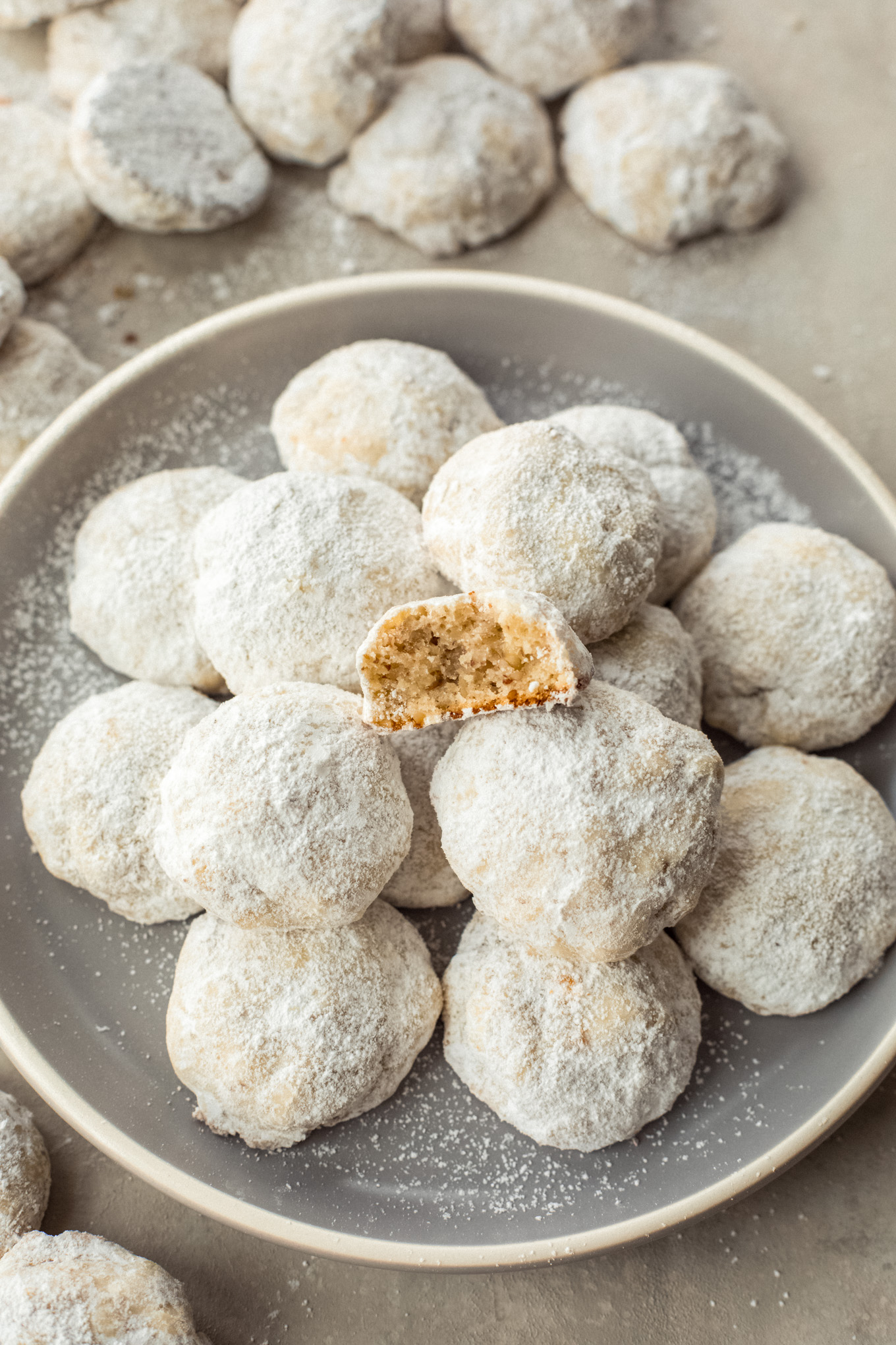 Pecan cookies on a plate with a cookie split in half.