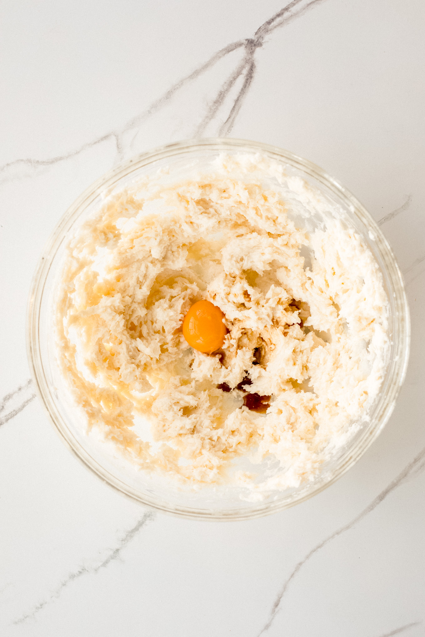 whipped sugar with butter and egg yolk in a bowl.