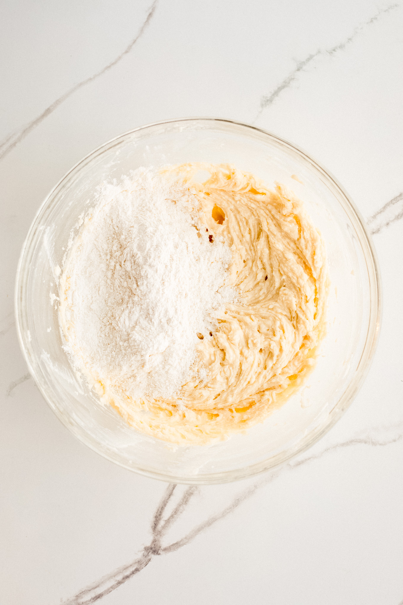 dry ingredients with wet ingredients in a glass bowl.