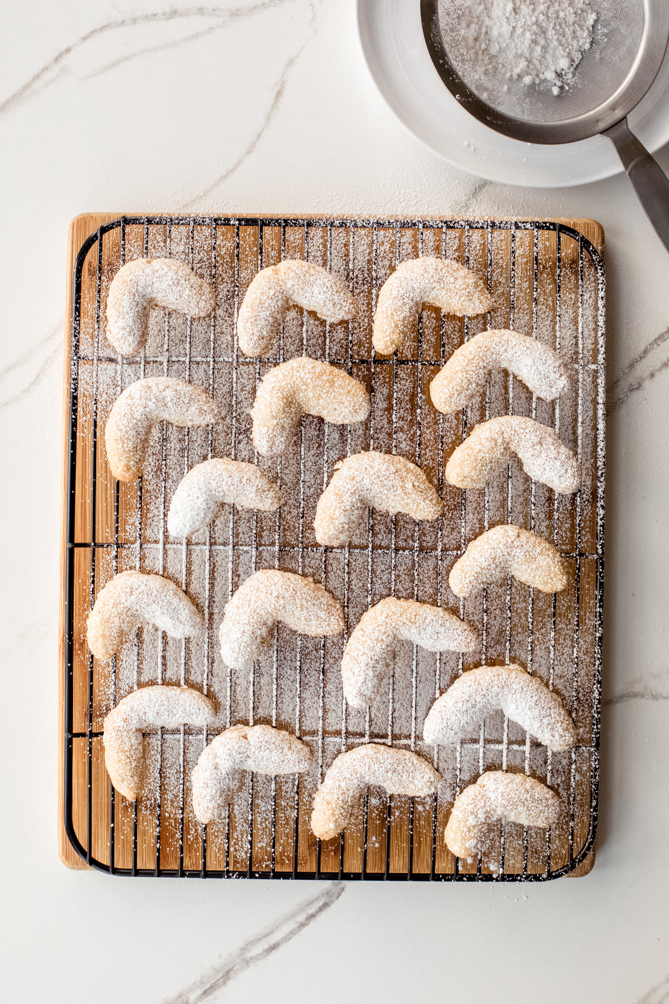 cookies on a wire rack dusted with powdered sugar.