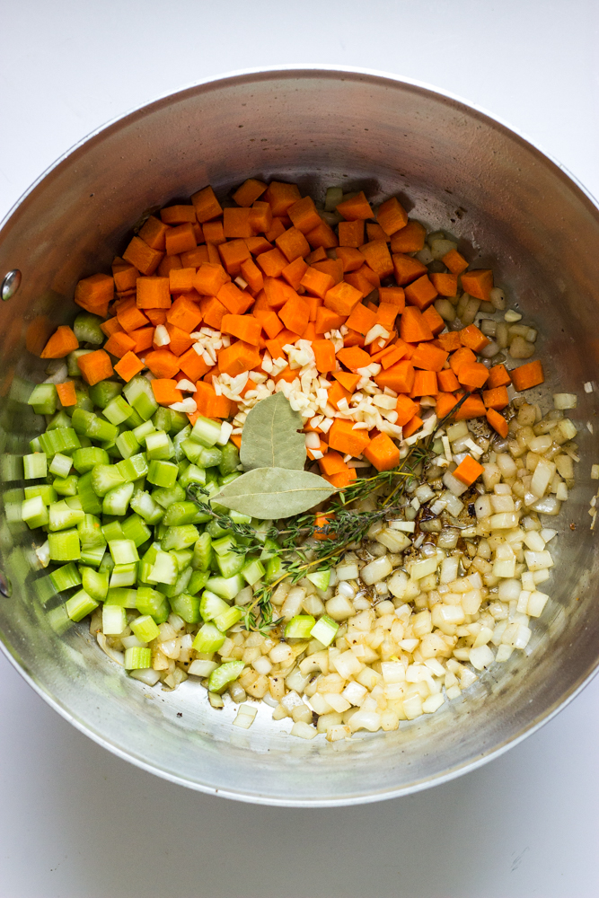 onions, carrots, and celery inside a dutch oven.