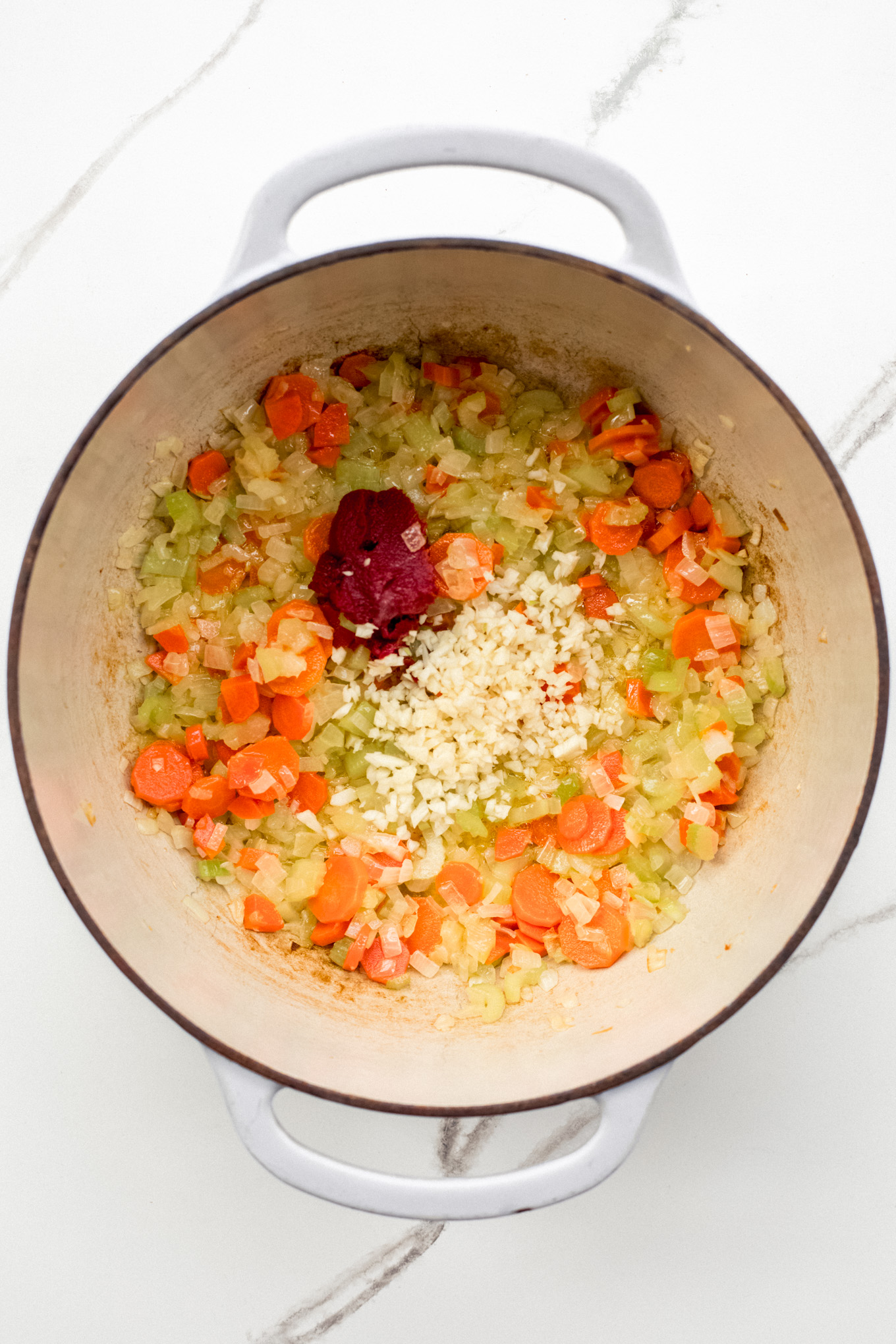 sauteed vegetables in a soup pot.