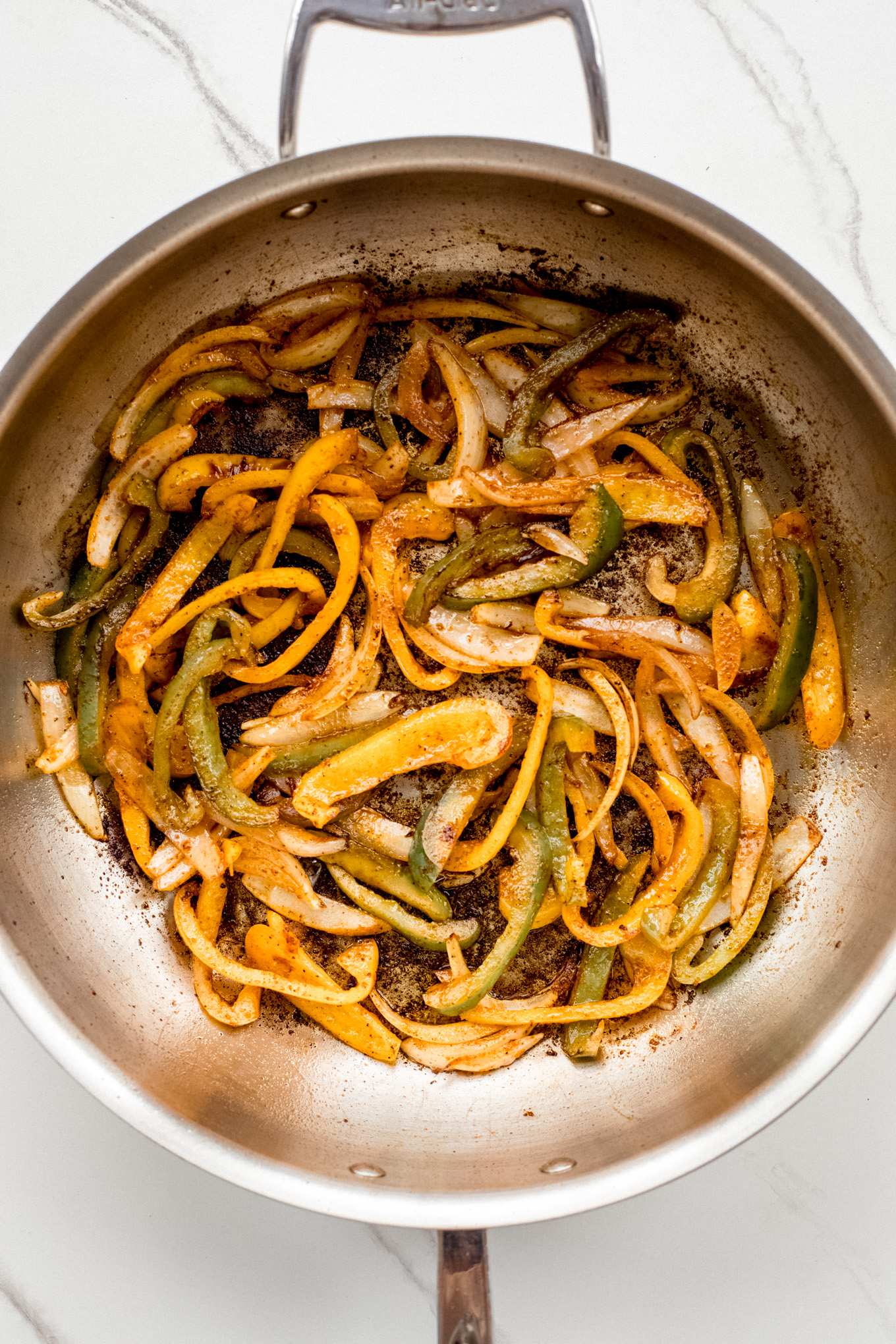 cooked bell peppers in saute pan.