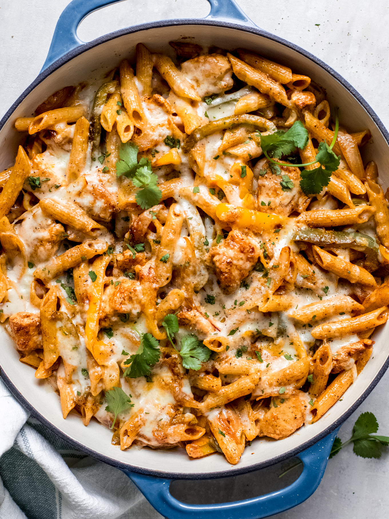 chicken fajita pasta in a pan garnished with cilantro.