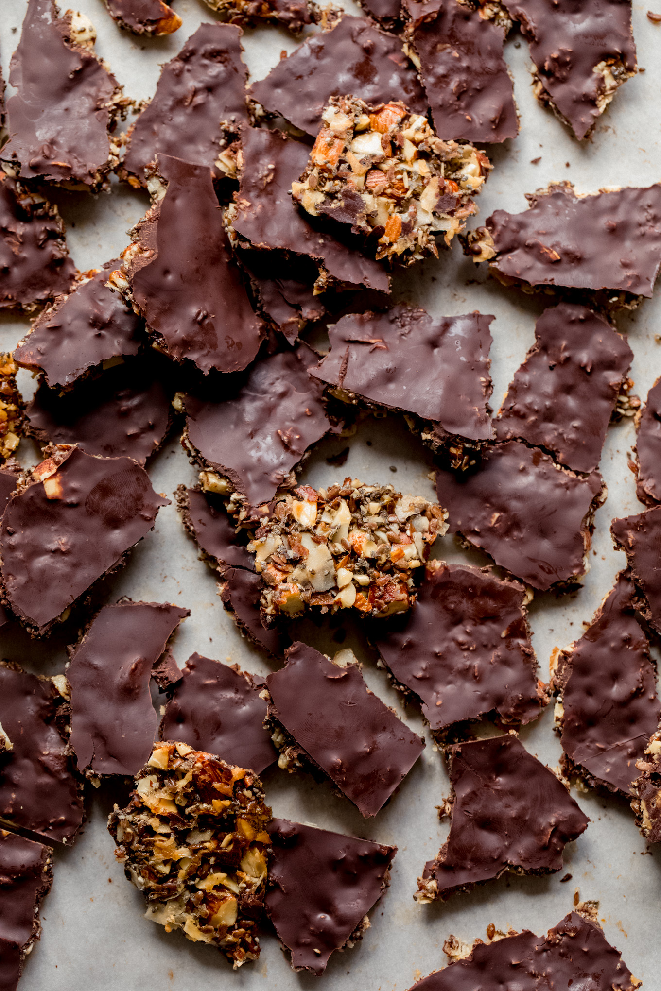 nut and seed bark spread on a parchment lined sheet pan.