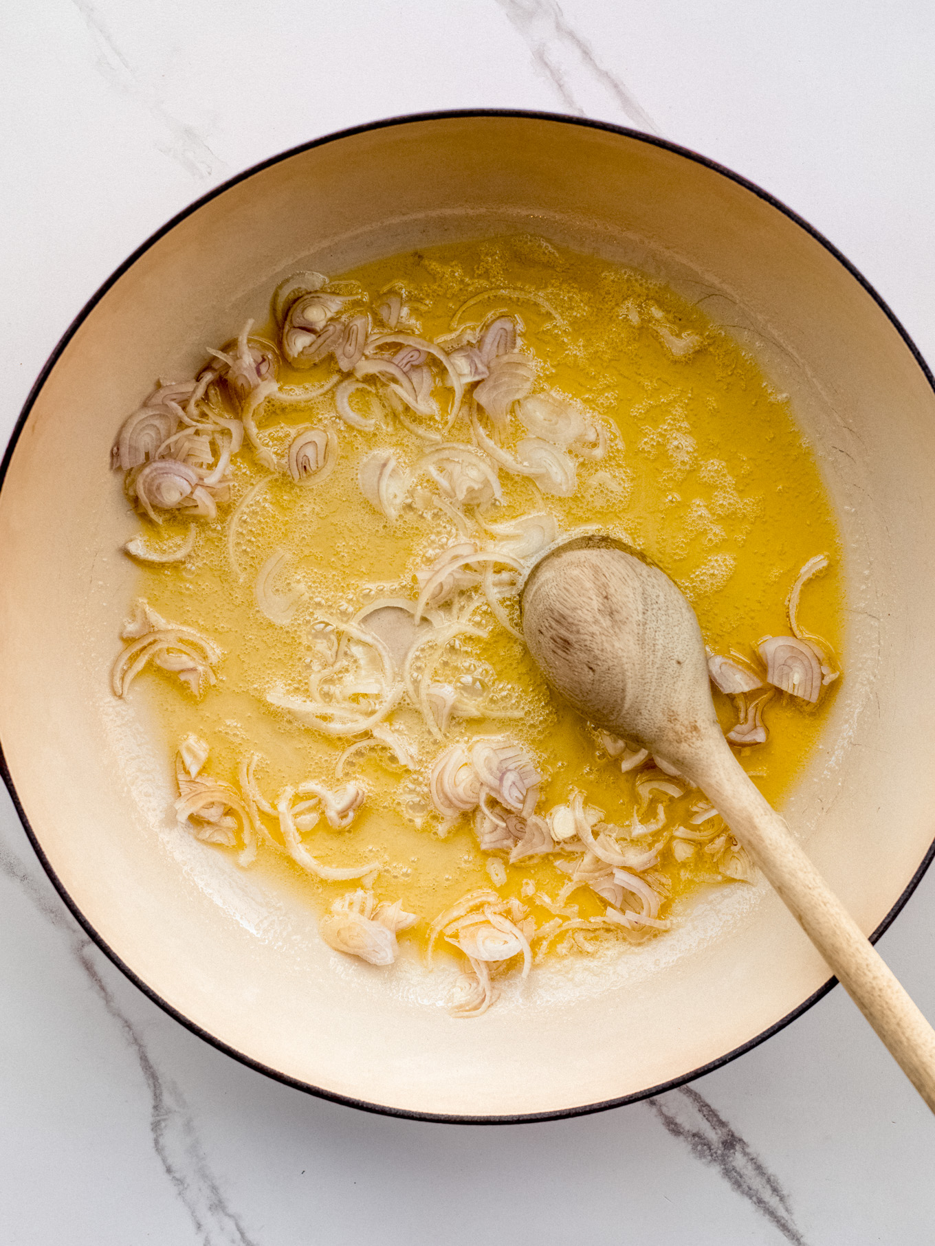 sauteed shallots in a saute pan.