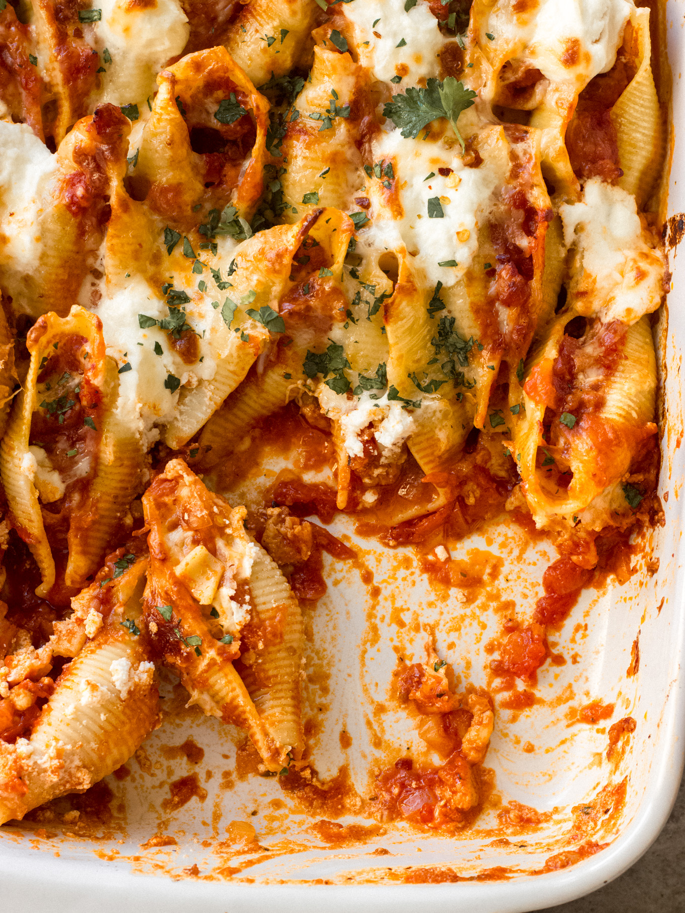 close up stuffed pasta shells with cheese and sausage.