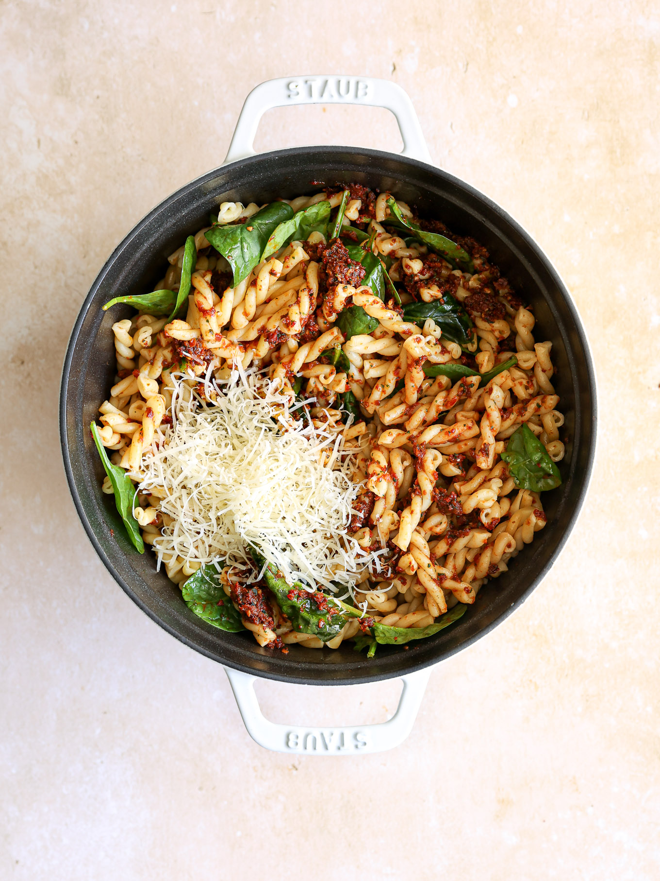 tossed pasta with spinach, pesto, and parmesan cheese.