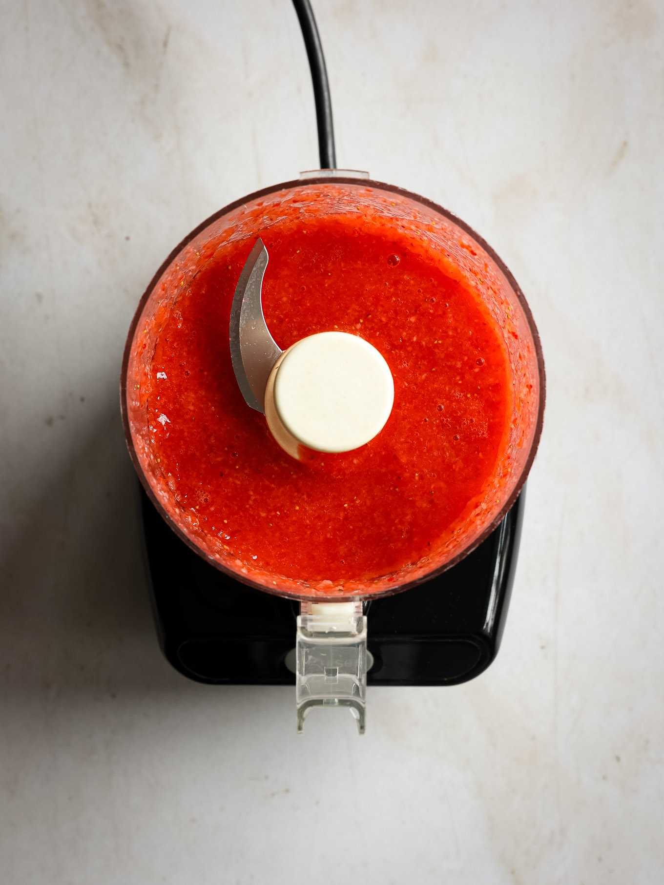 pureed stawberries in a food processor.