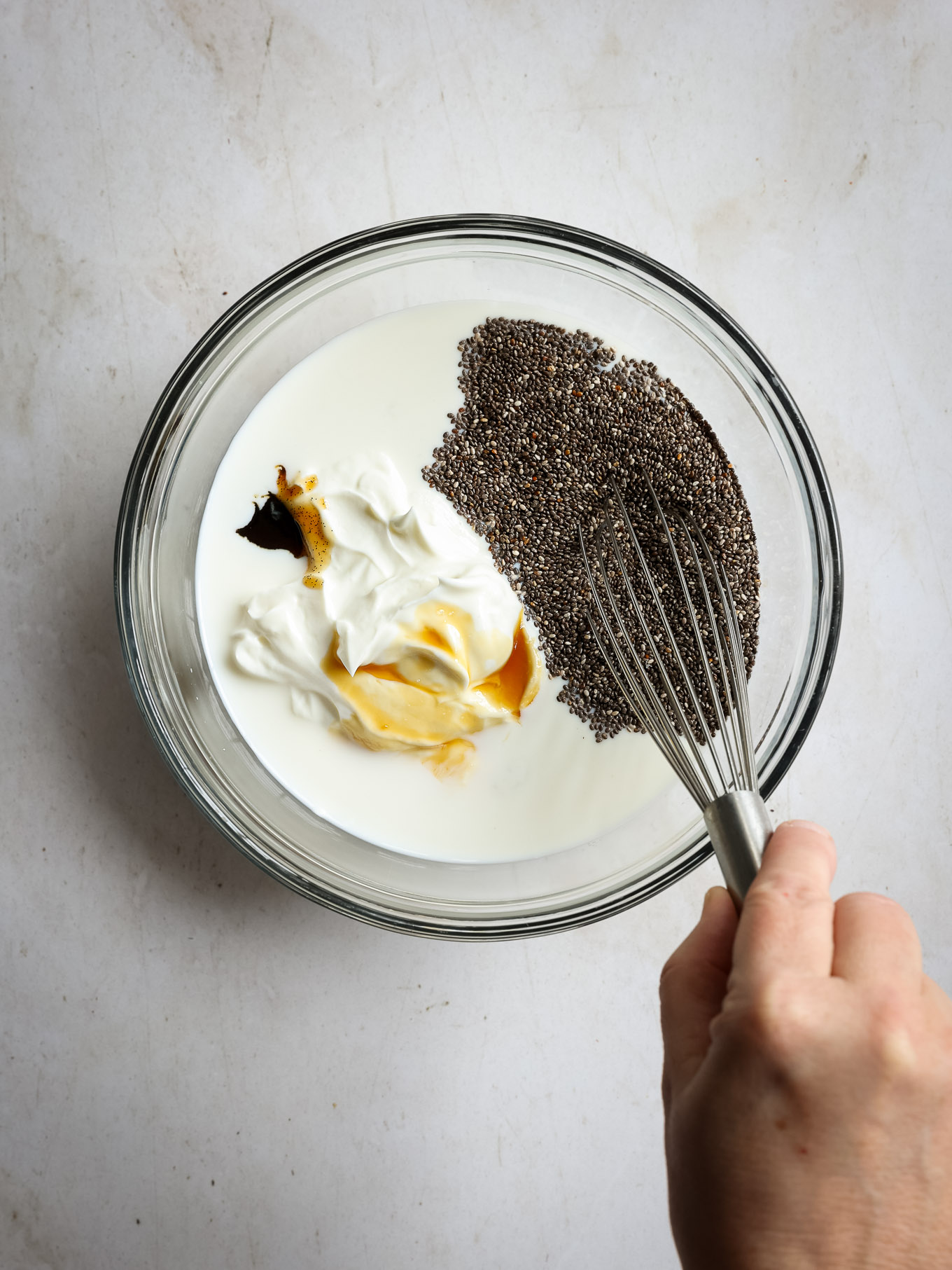 milk, chia seeds, and yogurt in a glass bowl.