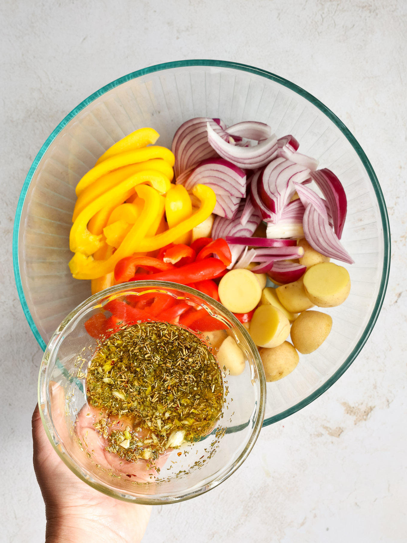 sliced peppers, onions, and potatoes in a bowl.