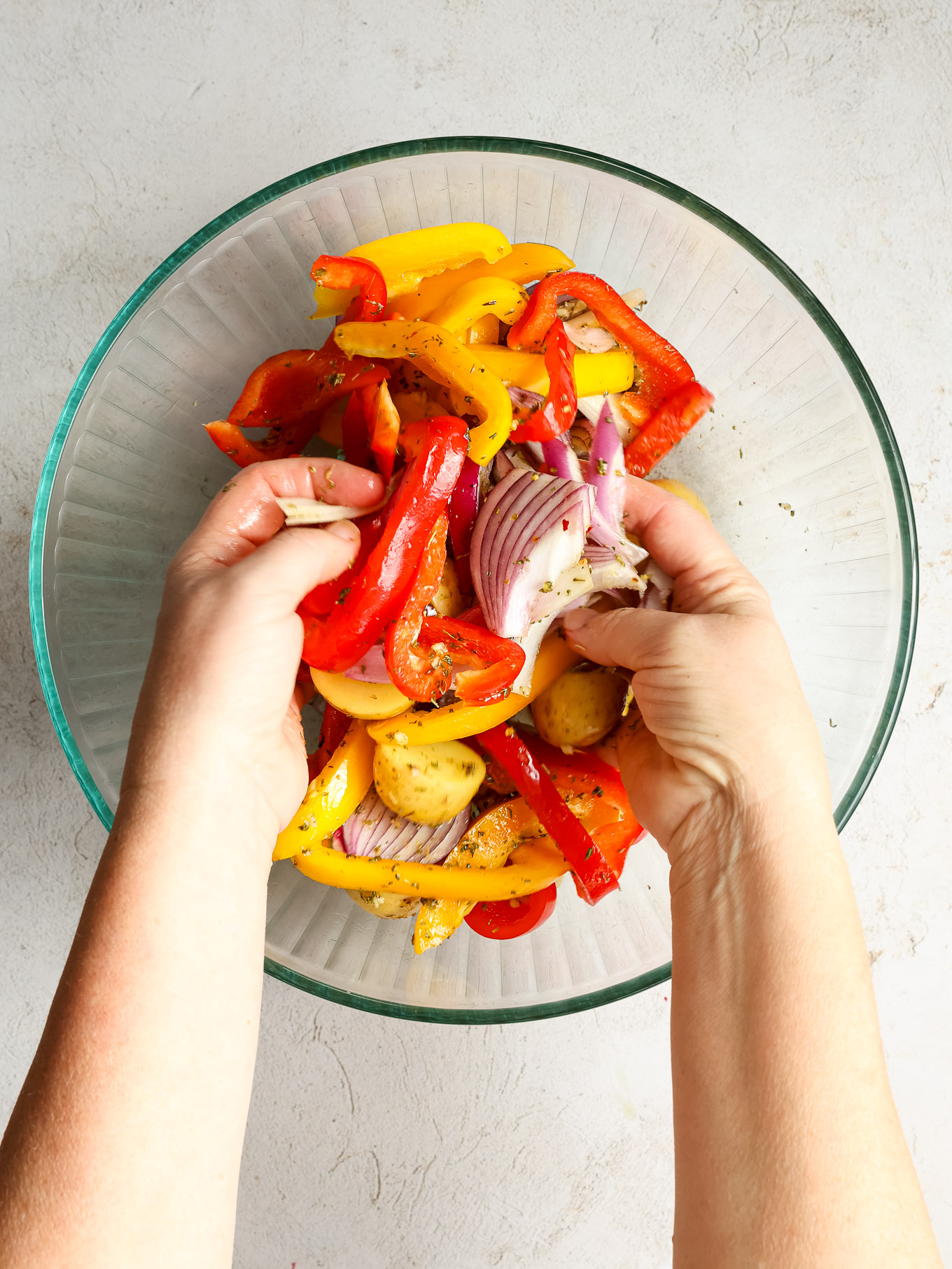 tossed vegetables with spices in a glass bowl.