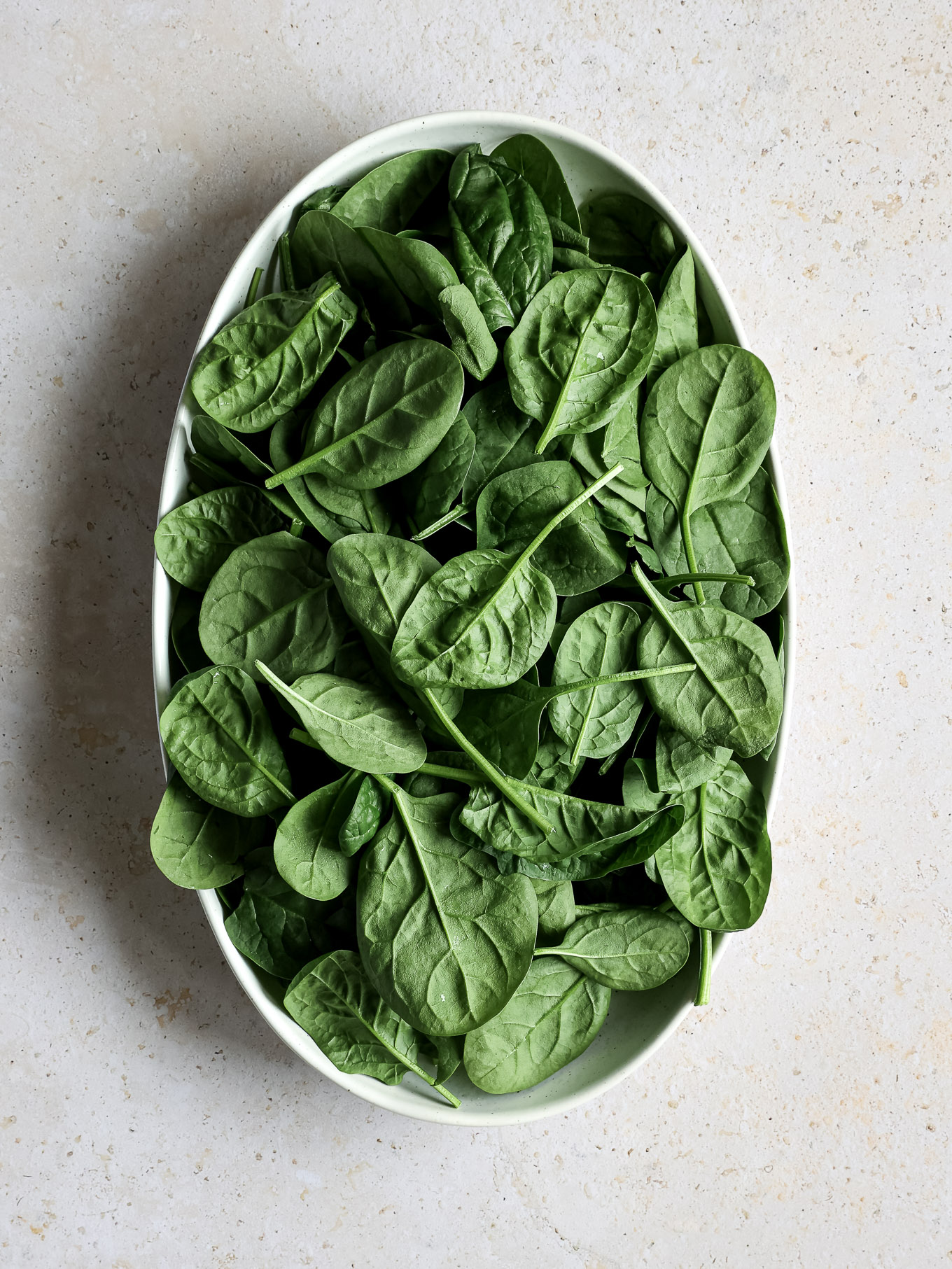 fresh baby spinach in a bowl.