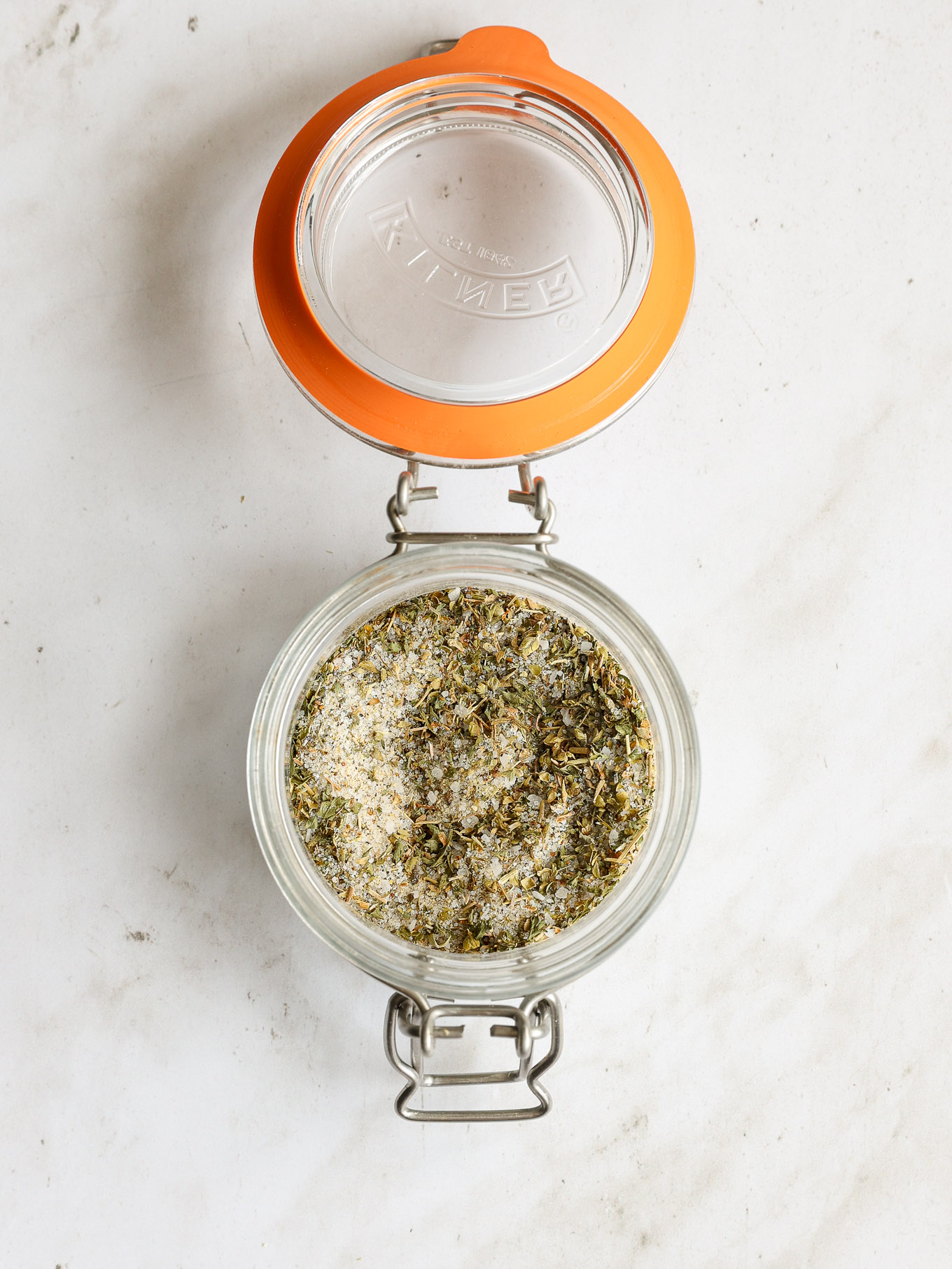 italian dressing spice mix in a glass jar with a lid.
