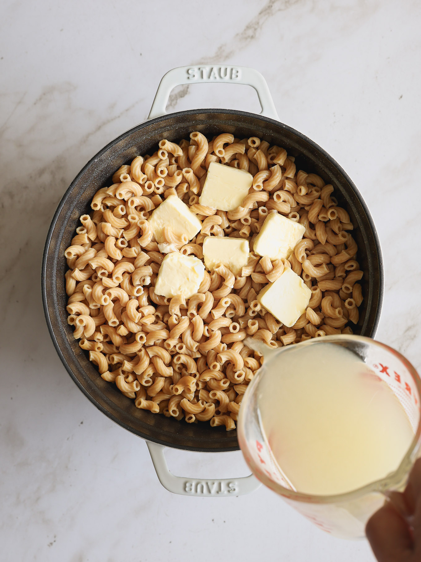 cooked macaroni with butter in a dutch oven.