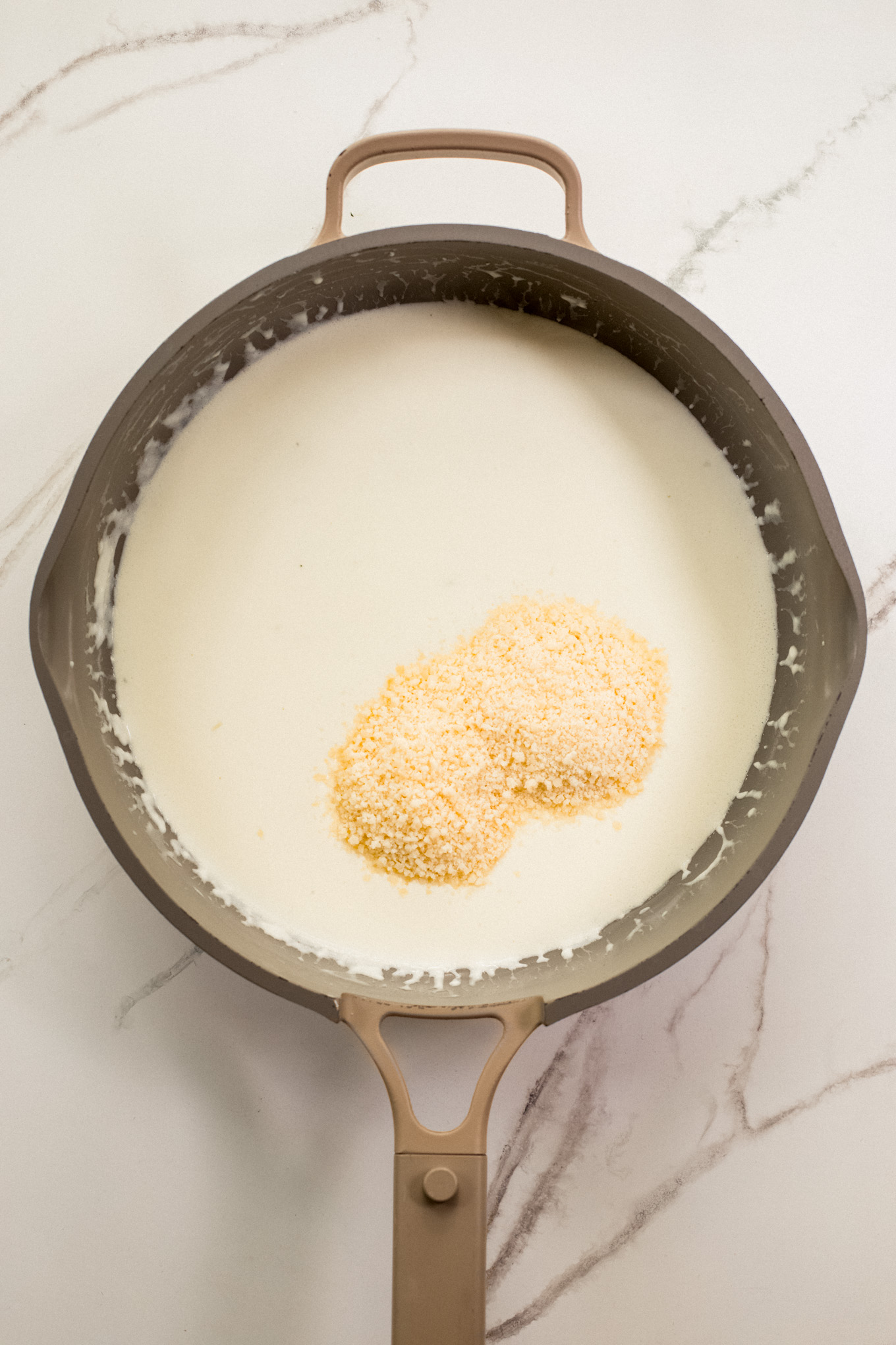 cream sauce with parmesan in saute pan.