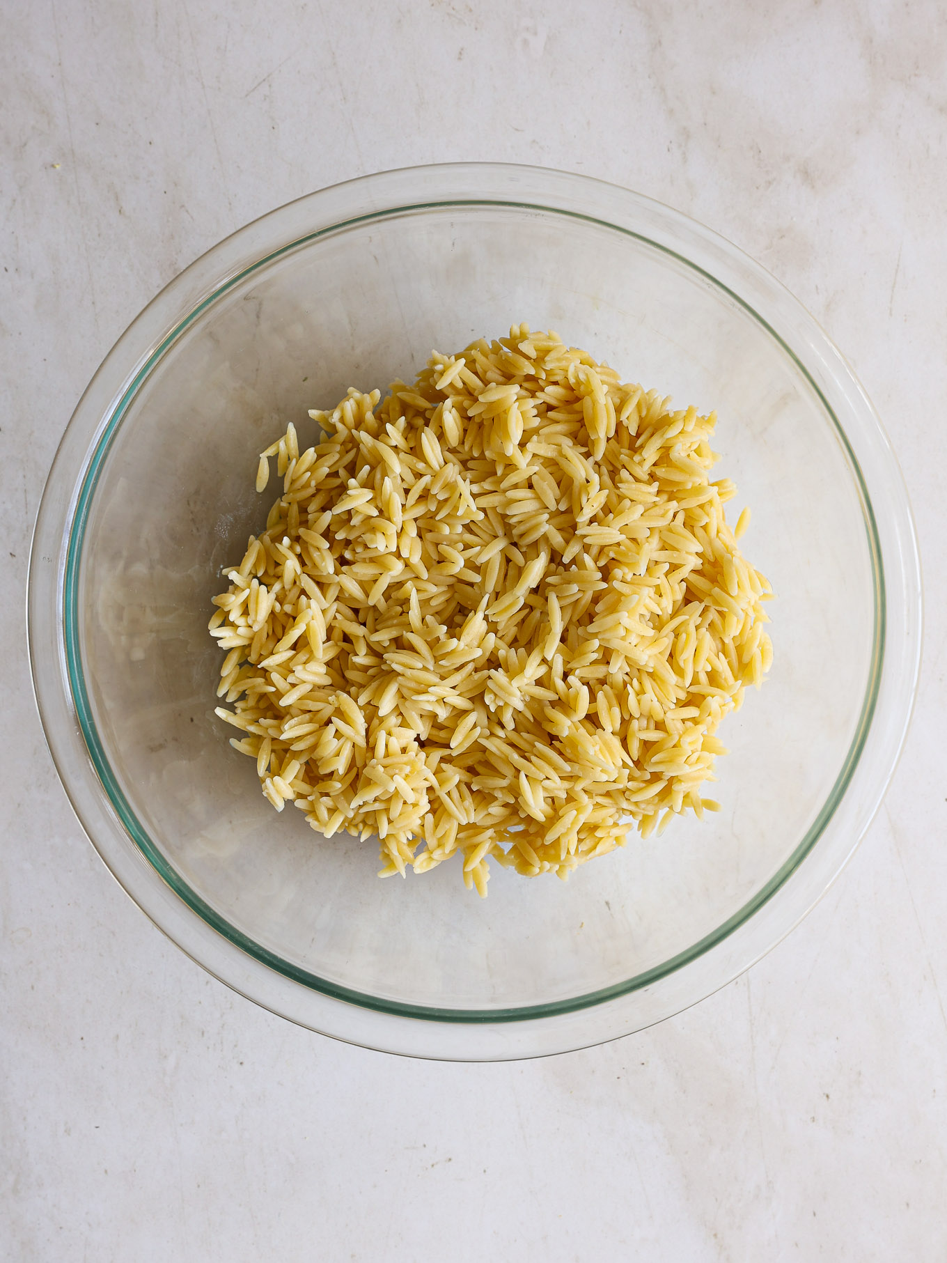 cooked orzo pasta in a glass bowl.